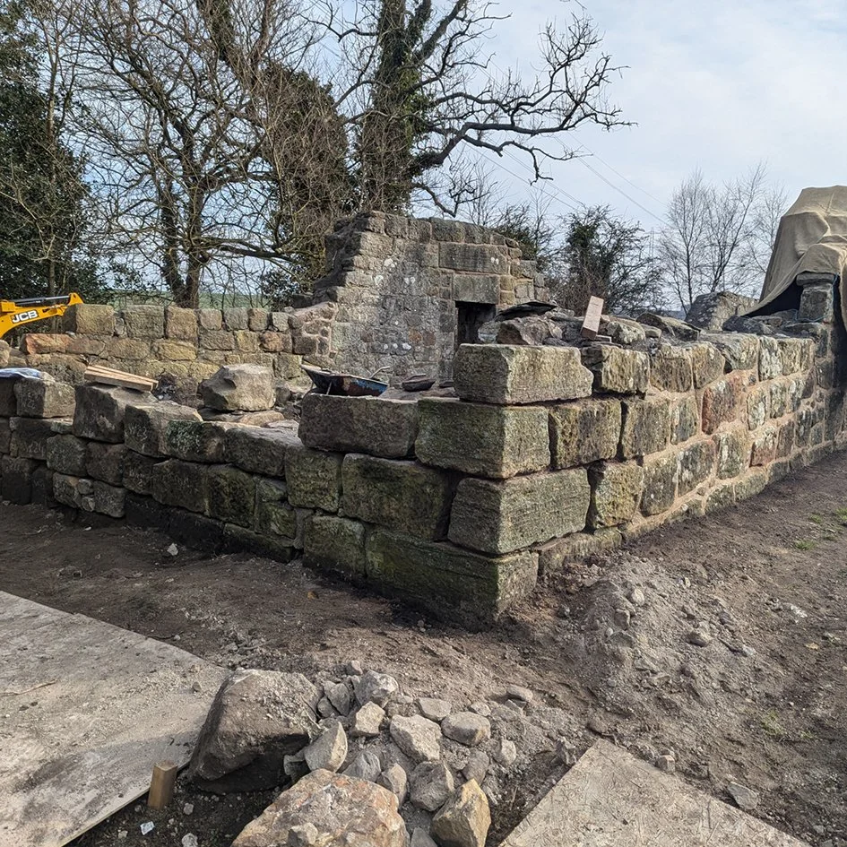 Rebuilding collapsed wall at West Kirk, Culross
