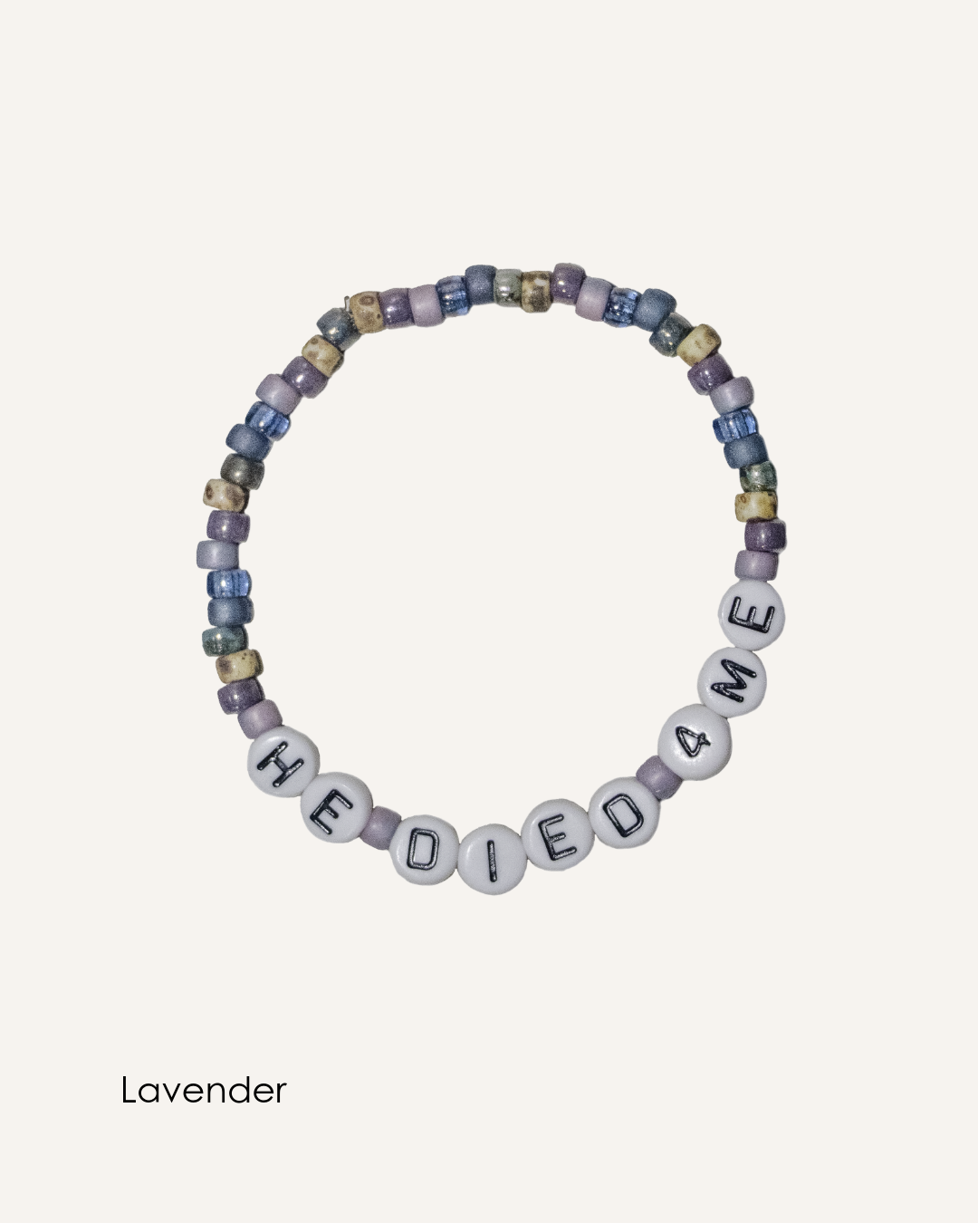 HE DIED 4ME handmade seed bead bracelet in Lavender colorway featuring soft purple rocaille beads and white alphabet beads on elastic band.