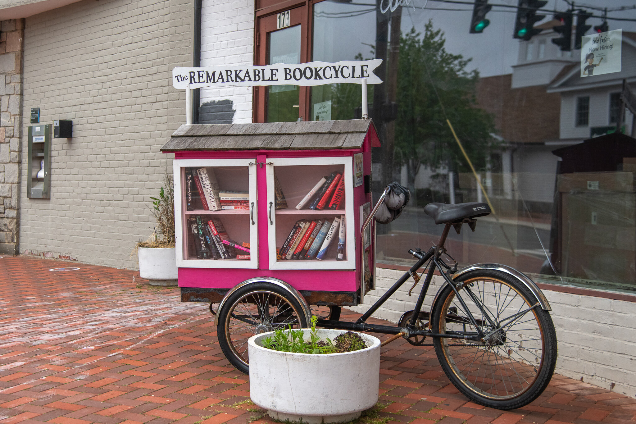 Westport’s famous pink Remarkable Bookcycle is now stationed on the sidewalk in front of 173 Main Street, the future home of Cold Fusion Gelato. The mobile free library offers free novels and children’s books to anyone who stops by, curated by a team of volunteer Remarkable Librarians. The bicycle was painted and retrofitted by Ryan Peterson with the lead of novelist Jane Green. The name and color come from the famous Remarkable Bookshop, which sat just up from the bike’s current spot before its closure.