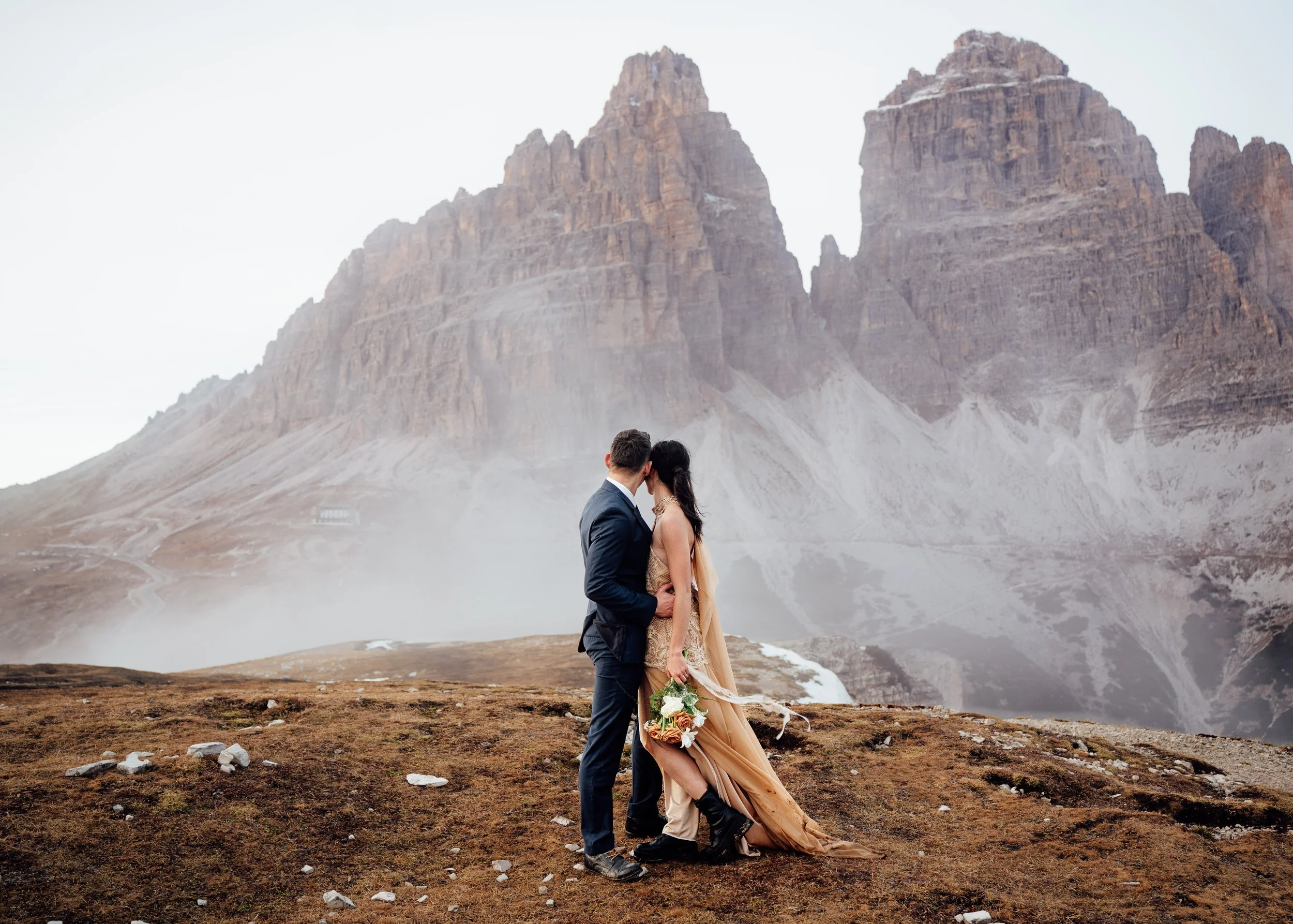 couple eloping at tre cime di lavaredo looking at iconic peaks
