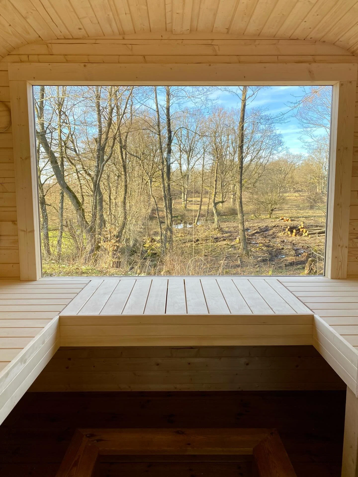 A room with a view. The sauna has landed, in good time for our first guests of the season. This bit of land was full of trees recently, but the land owners have thinned them out giving us a rather nice view. The cows and horses will visit in the summ