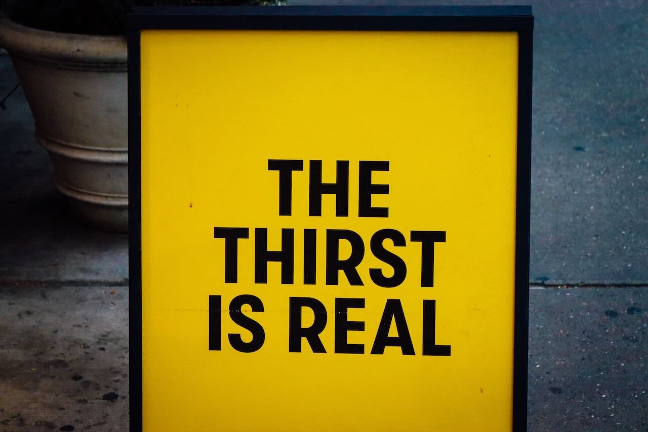 Yellow sign saying 'the thirst is real'