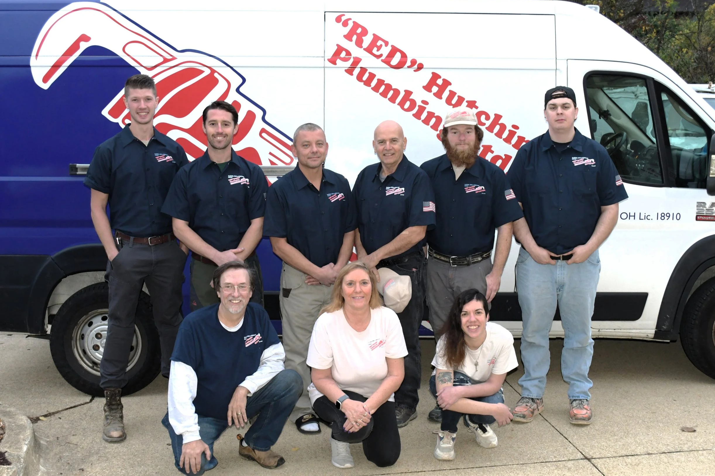 The Red Hutchins team in front of a truck with the company logo