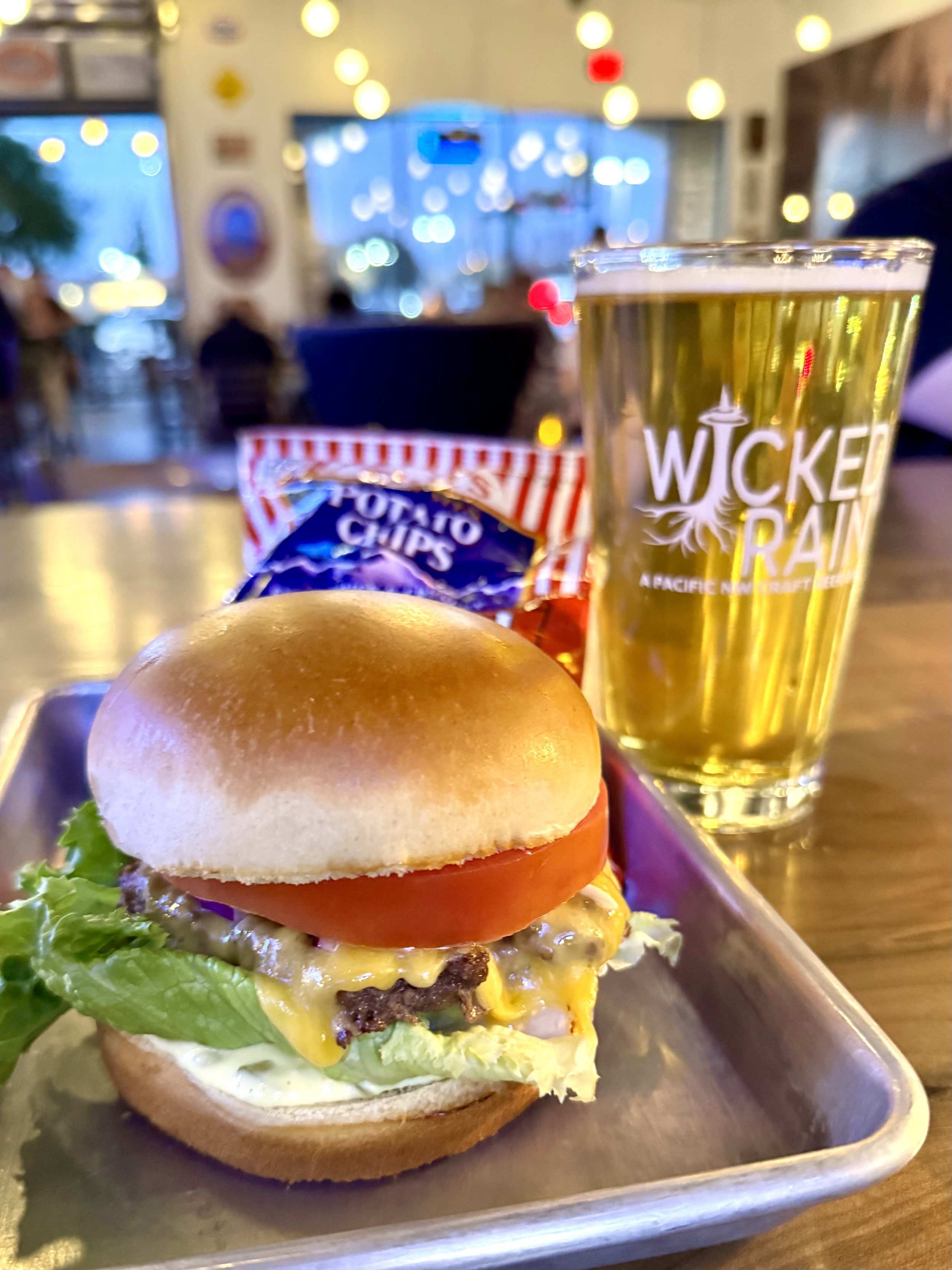 A Smashburger with cheese, Tim's Cascade chips, and beer at Wicked Rain