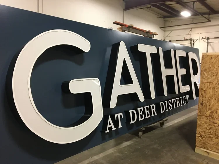 Gather at the Deer district exterior illuminated in shop.webp