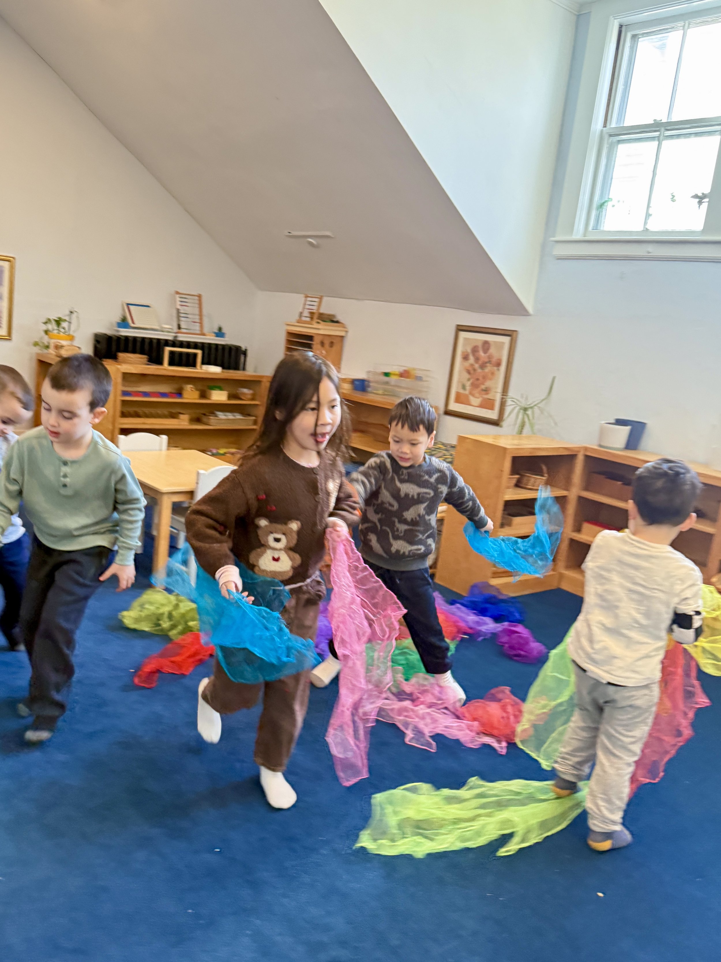children laughing and dancing, Montessori spaces, fun class