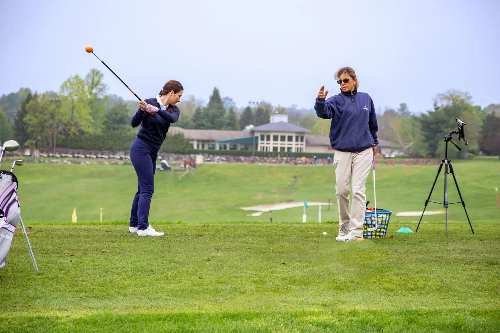 Mary Beth Kohberger teaching a beginner golfer