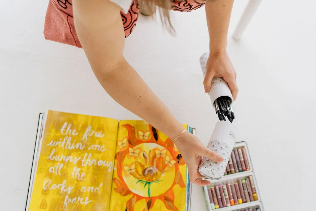 Art therapist in Denver, Leanne Morton, cleaning up art art supplies.