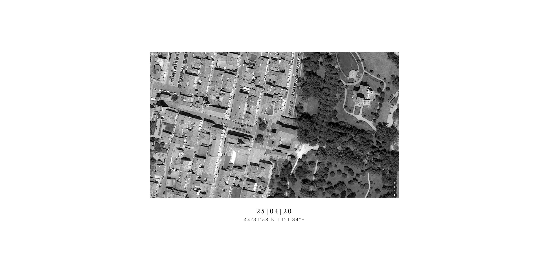 Black and white aerial view of buildings and a park area with roads, trees, and open spaces. Coordinates and date are noted below.