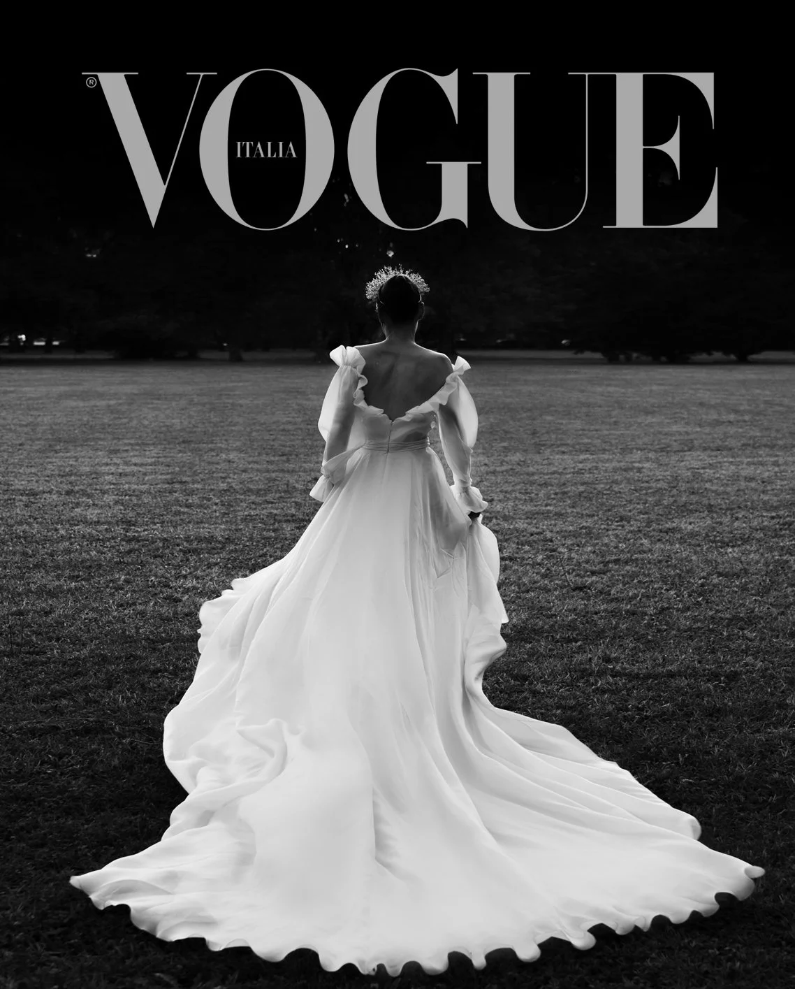 Vogue Italia cover featuring a person in a flowing white gown with a train, wearing a tiara, seen from behind, standing on grass.