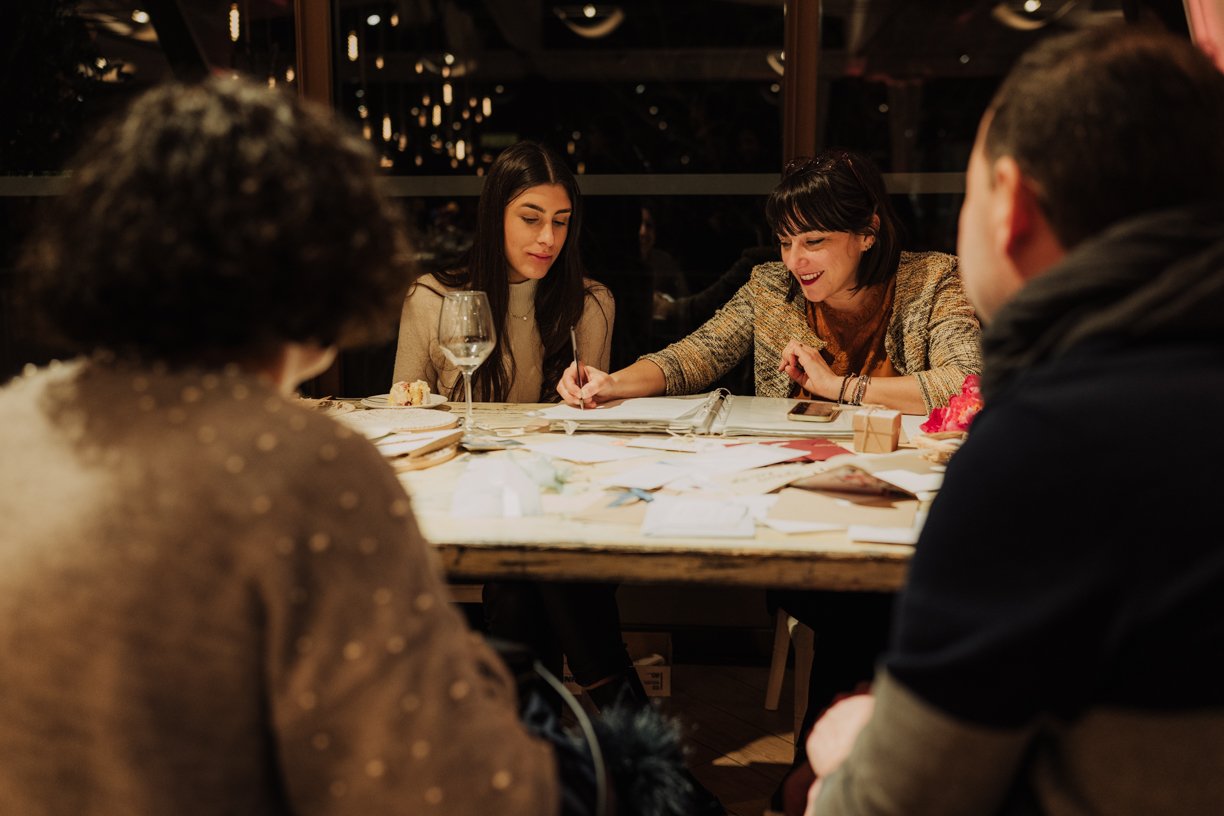 Group of people sitting around a table engaged in a creative activity