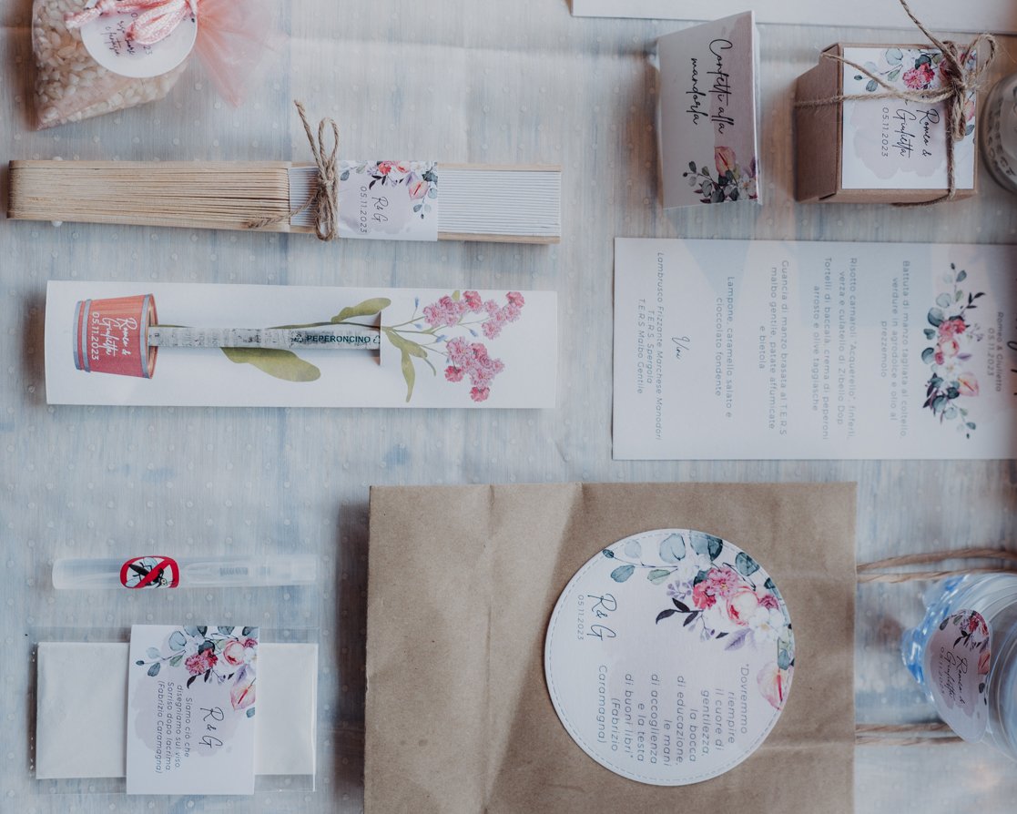 Wedding stationery and favors featuring floral designs, including invitations, thank-you cards, and gift packages wrapped in rustic style.