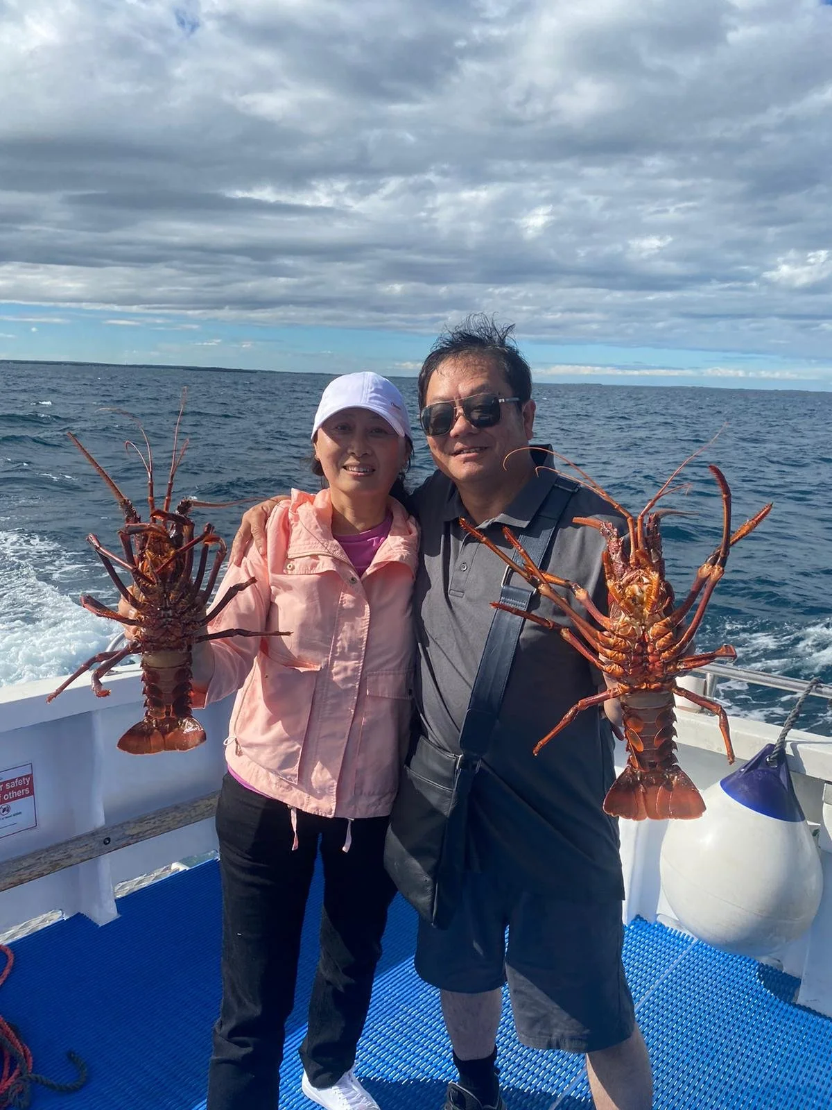 Visitors holding Western Rock Lobsters during the Rock Lobster Tourism Trial experience in Jurien Bay.