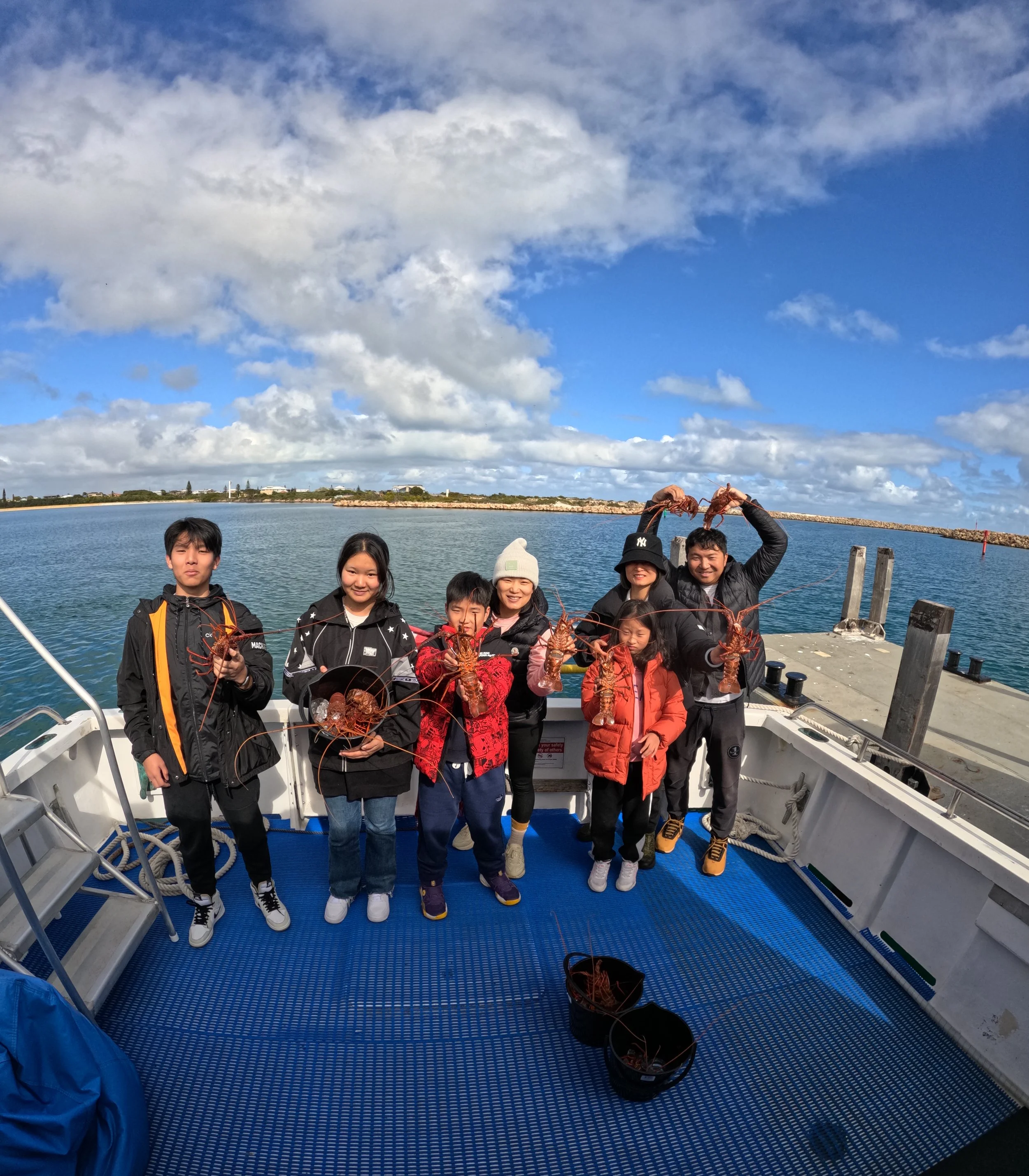 Visitors holding Western Rock Lobsters during the Rock Lobster Catch & Keep Experience in Jurien Bay.