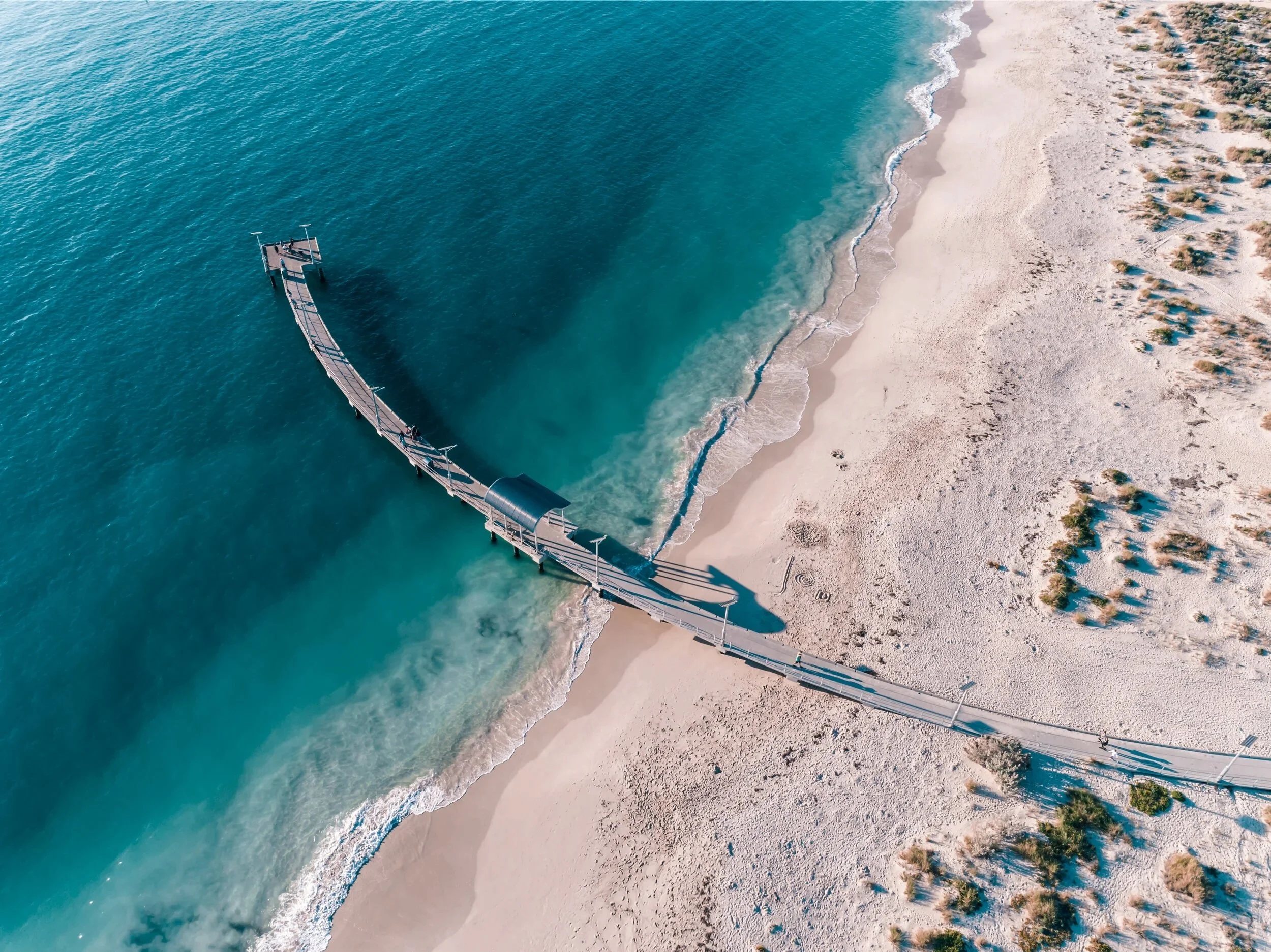 Jurien Bay Jetty taking from above showing turquoise waters of Australias Coral Coast, Western Australia.