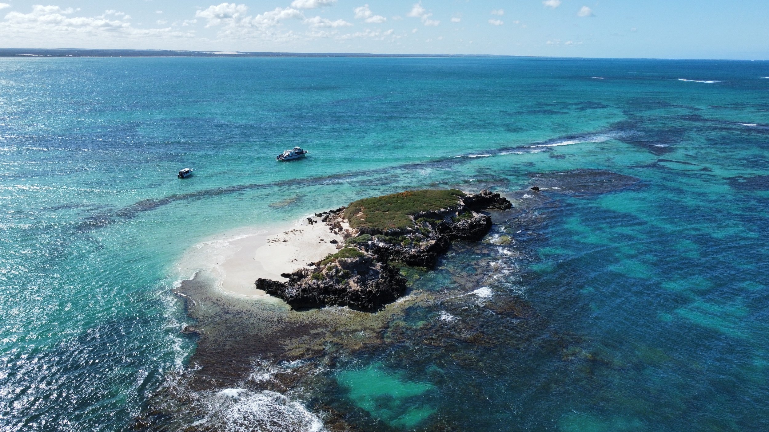 Aerial view of an island and surrounding reef within the Jurien Bay Marine Park, Western Australia.