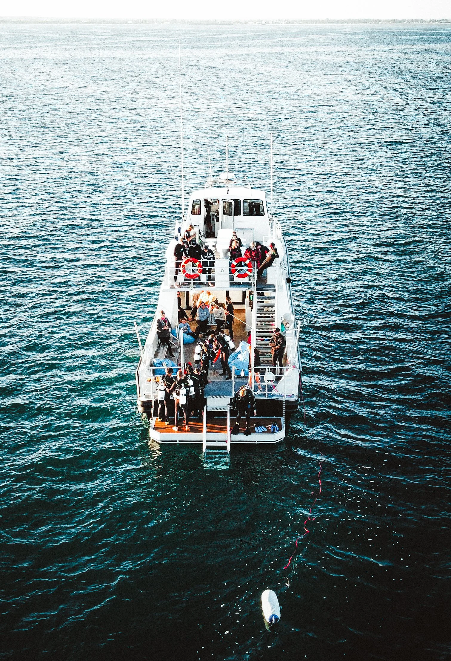 Aerial view of Jurien Bay Oceanic Experience's MV High Voltage with guests preparing for a marine adventure in Jurien Bay, Western Australia.