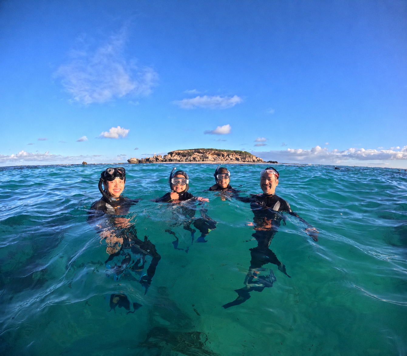 Snorkelling family enjoying the clear waters on a sea lion tour in Jurien Bay, Western Australia.