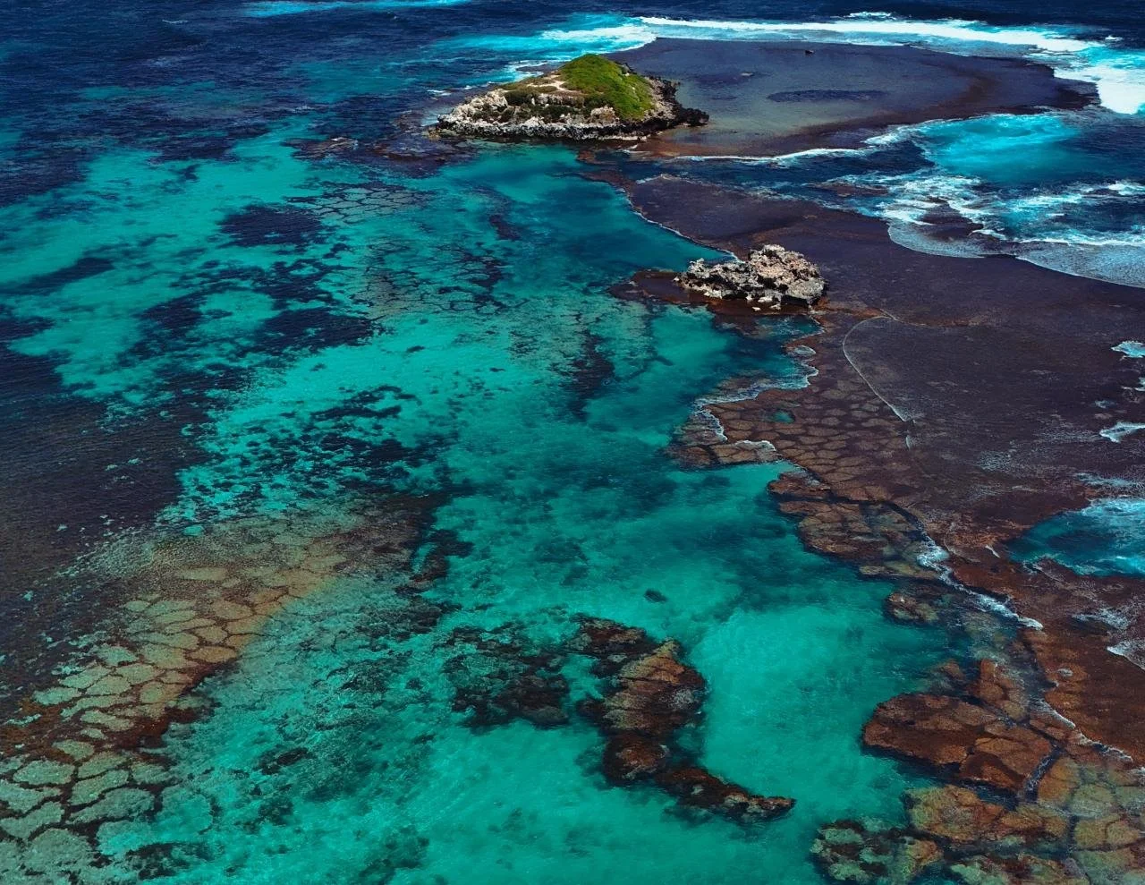 An aerial view of the turquoise reefs and islands of Western Australia's Coral Coast.