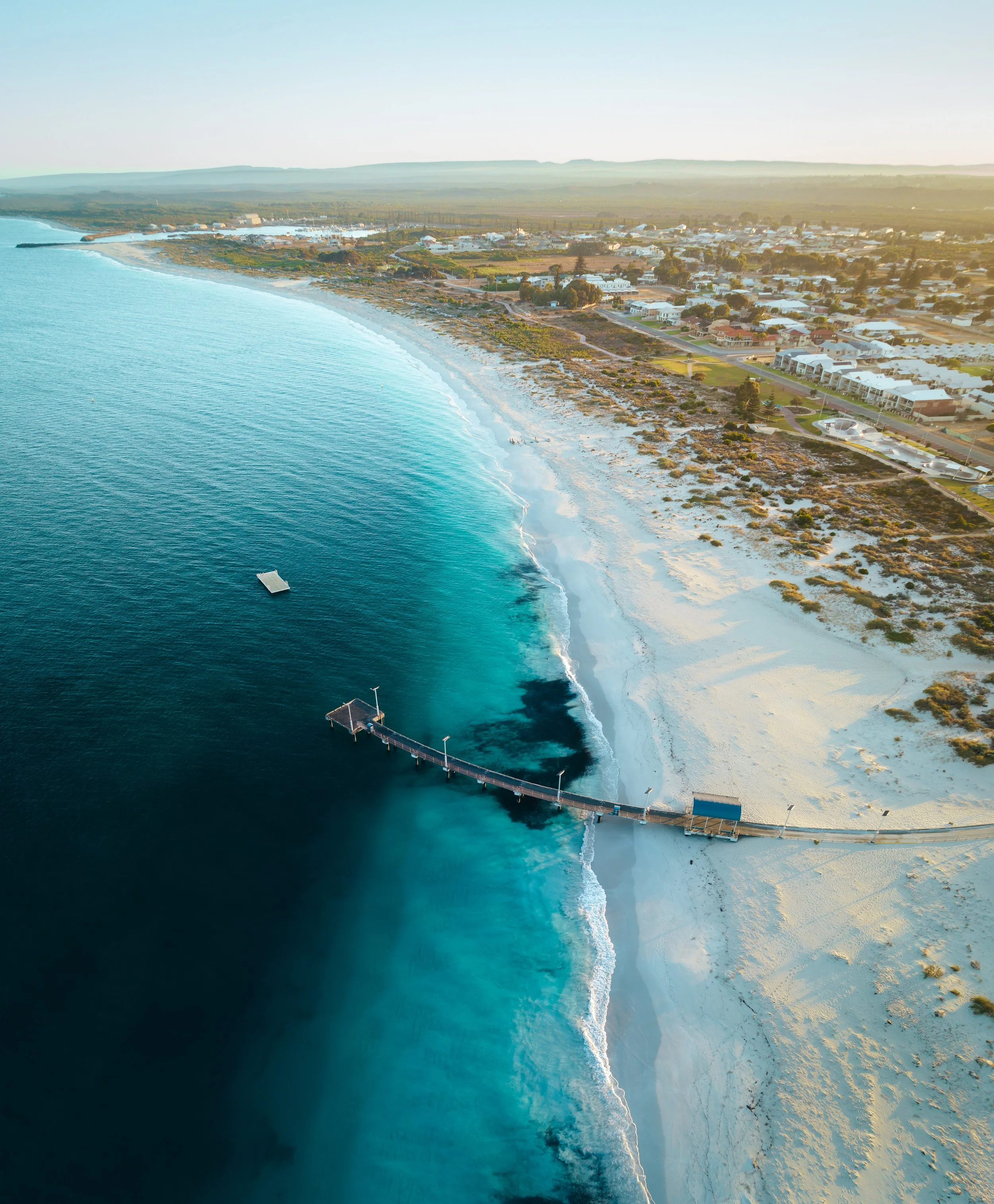 Aerial view of Jurien Bay Jetty, the beach and turquoise water along the town foreshore.