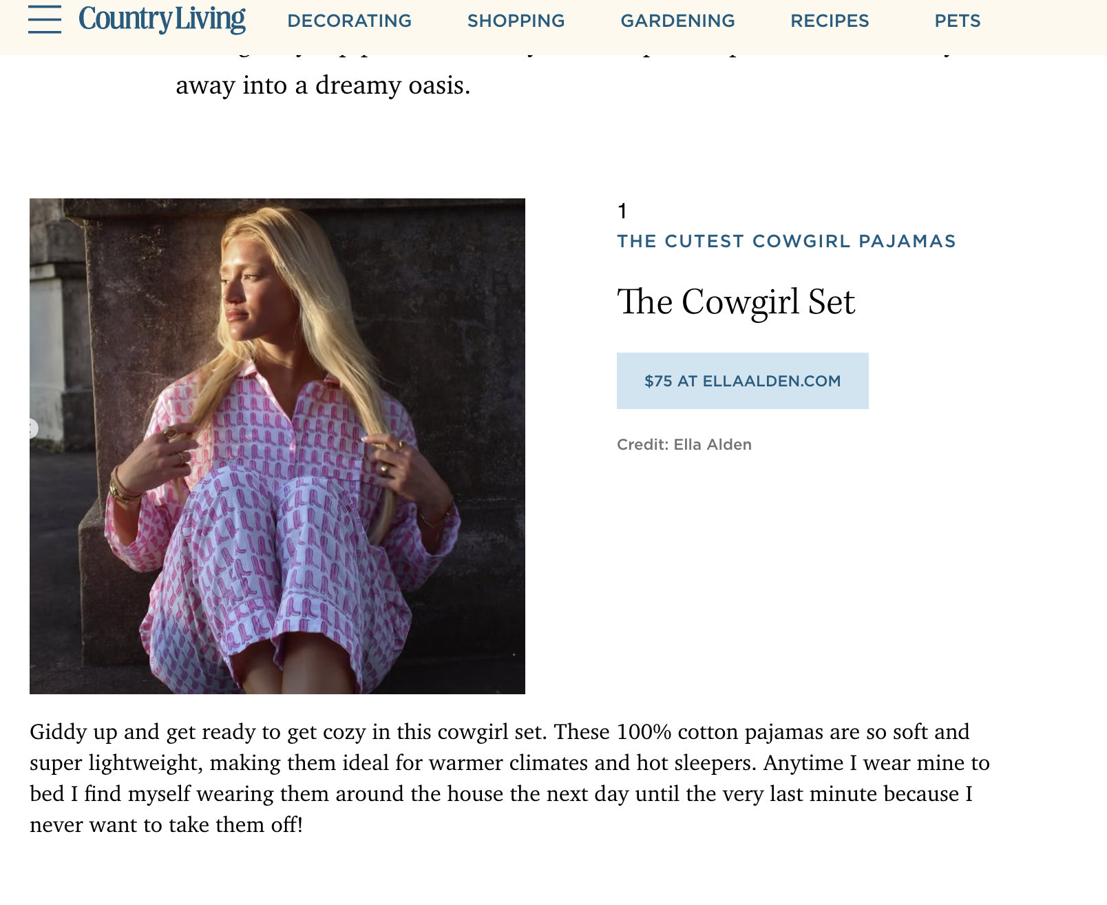 A woman with long blonde hair sitting outdoors leaning against a stone wall, wearing a pink cowgirl pajama set with a repeating pattern of small cowgirl icons, and gazing into the distance.