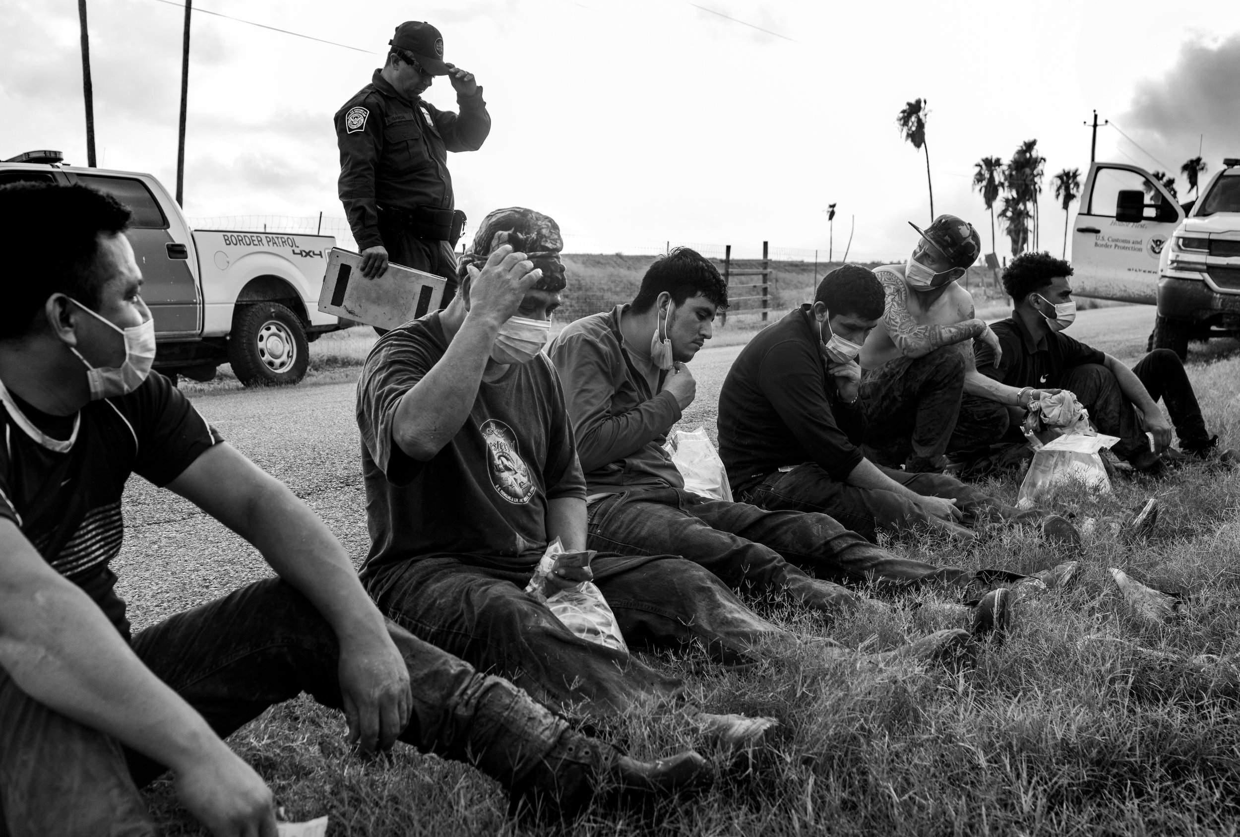  Migrant “runners” wait handcuffed after trying to evade Border Patrol in La Joya, Texas. 