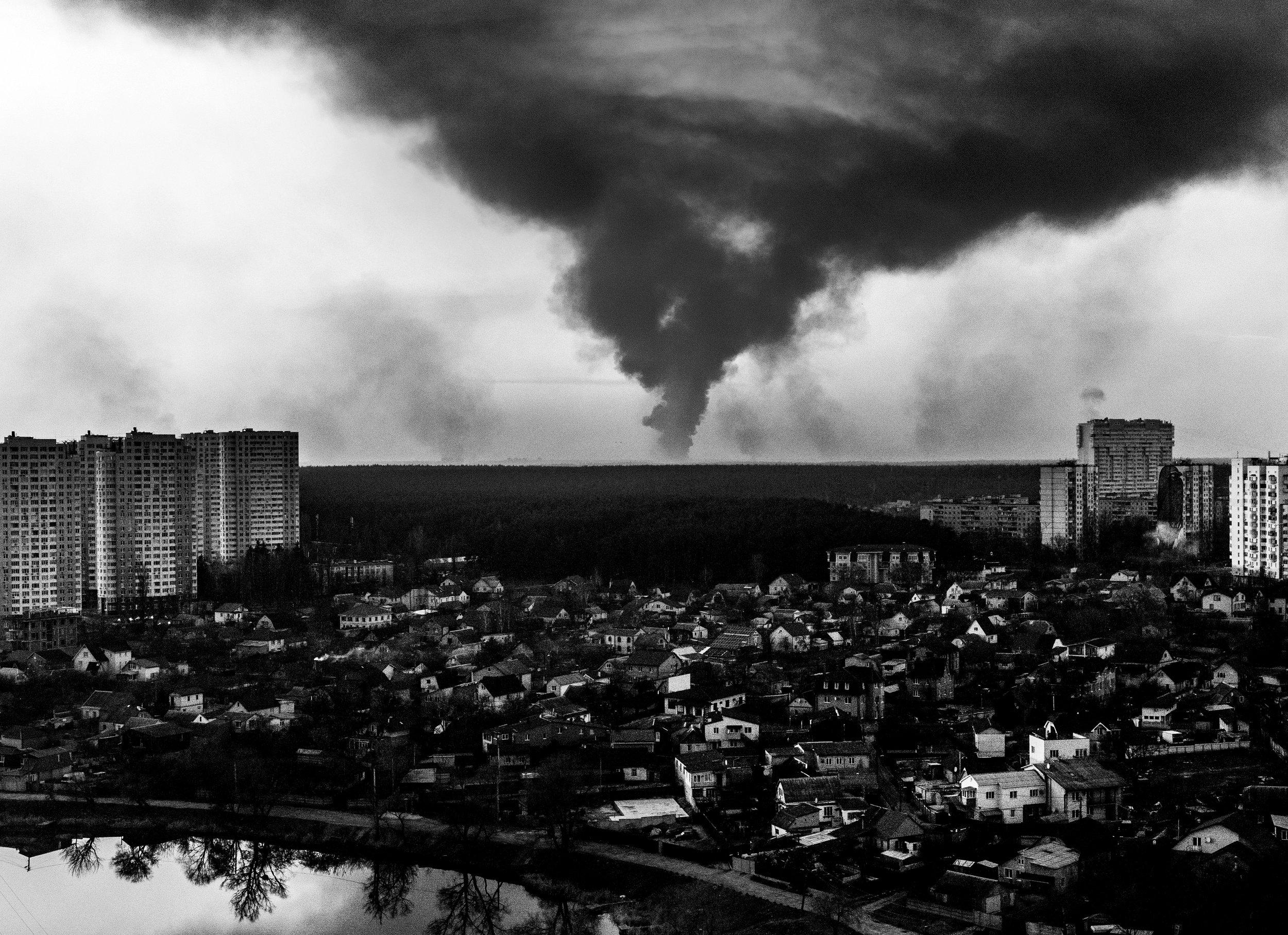  Multiple explosions from Irpin and surrounding regions are seen from the top floor balcony of a residential building in Kyiv. 