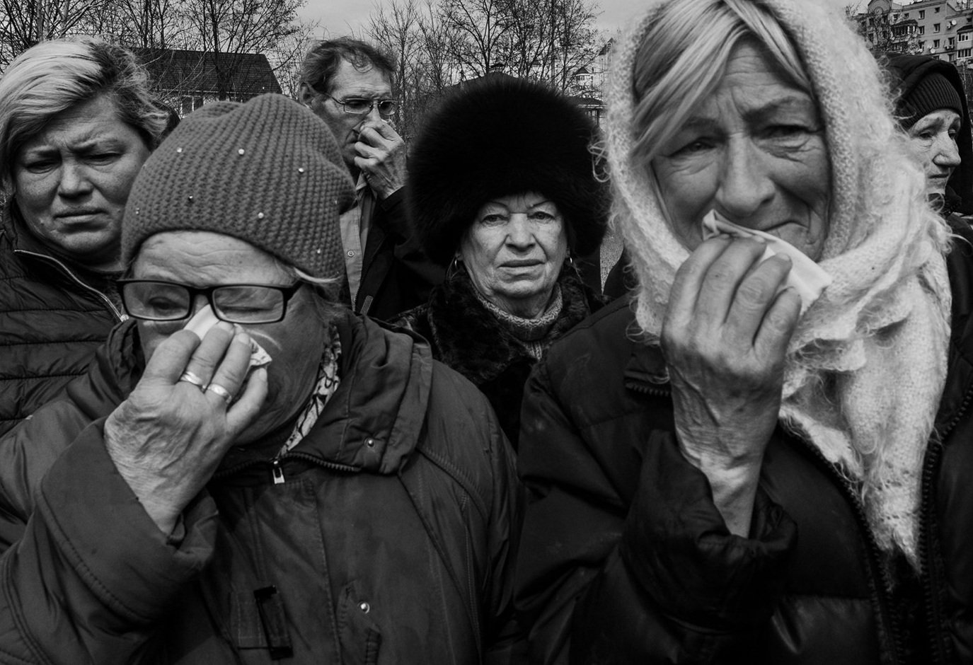  Family members grieve at the site of a mass grave in Bucha, Ukraine as bodies are exhumed for investigation of war crimes after one month of Russian occupation. 