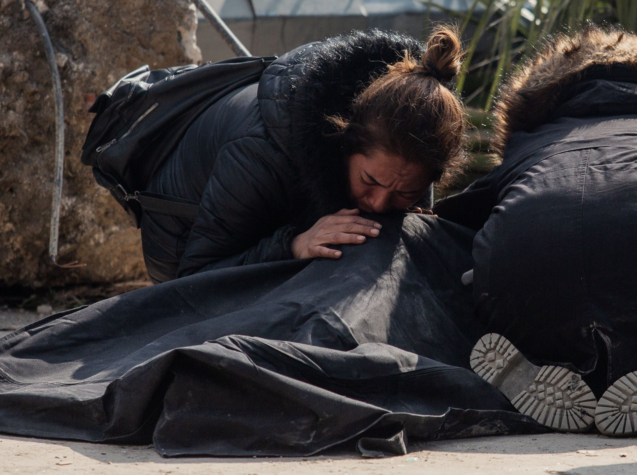  A woman says goodbye to her daughter in a body bag on February 11, 2022, in Hatay, Turkey. 