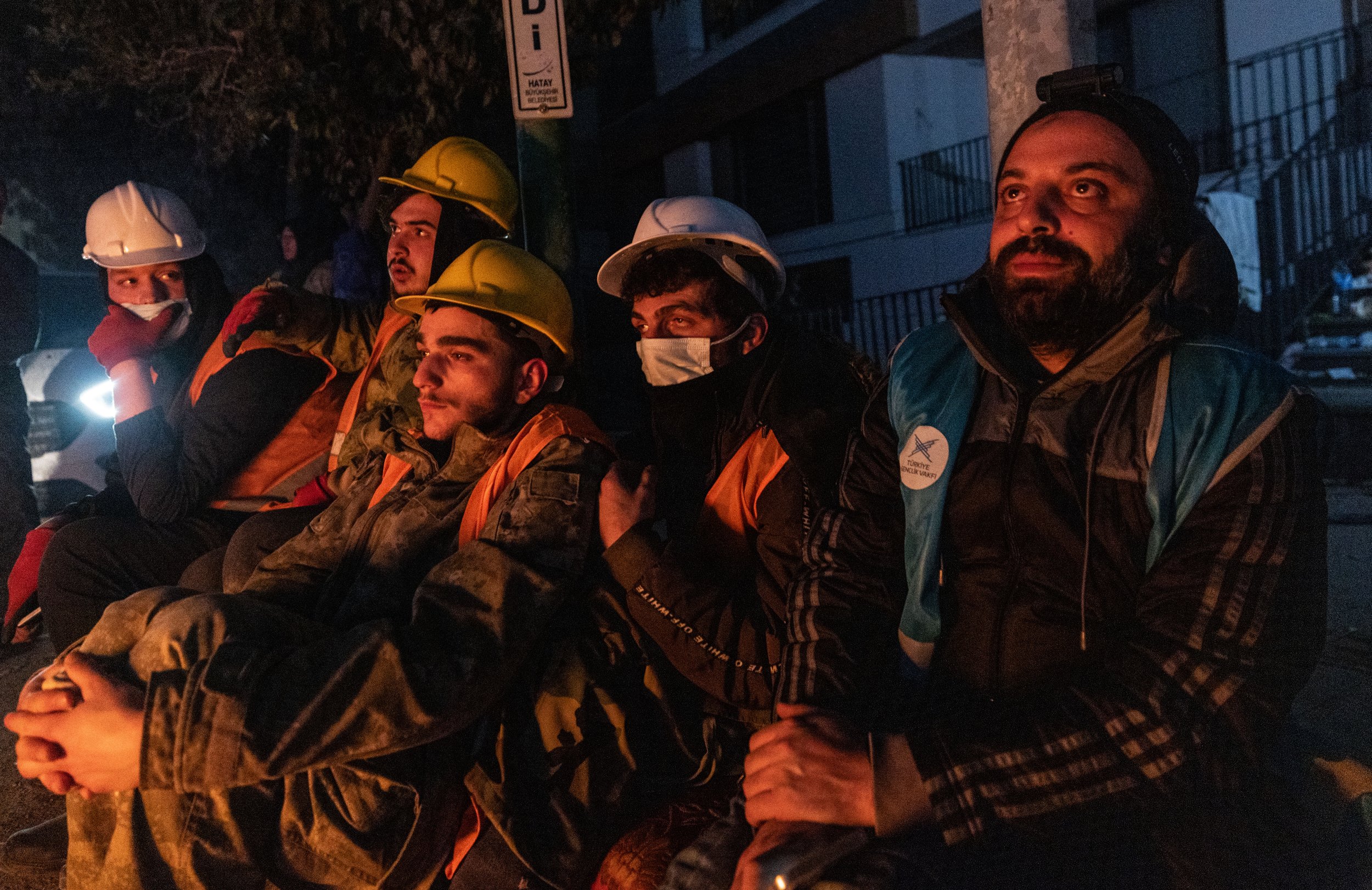 Volunteer rescue workers tear up by a fire in Haty, Turkey on February 13, 2023, after a failed thirty-hour rescue of a child beneath a collapsed building. 
