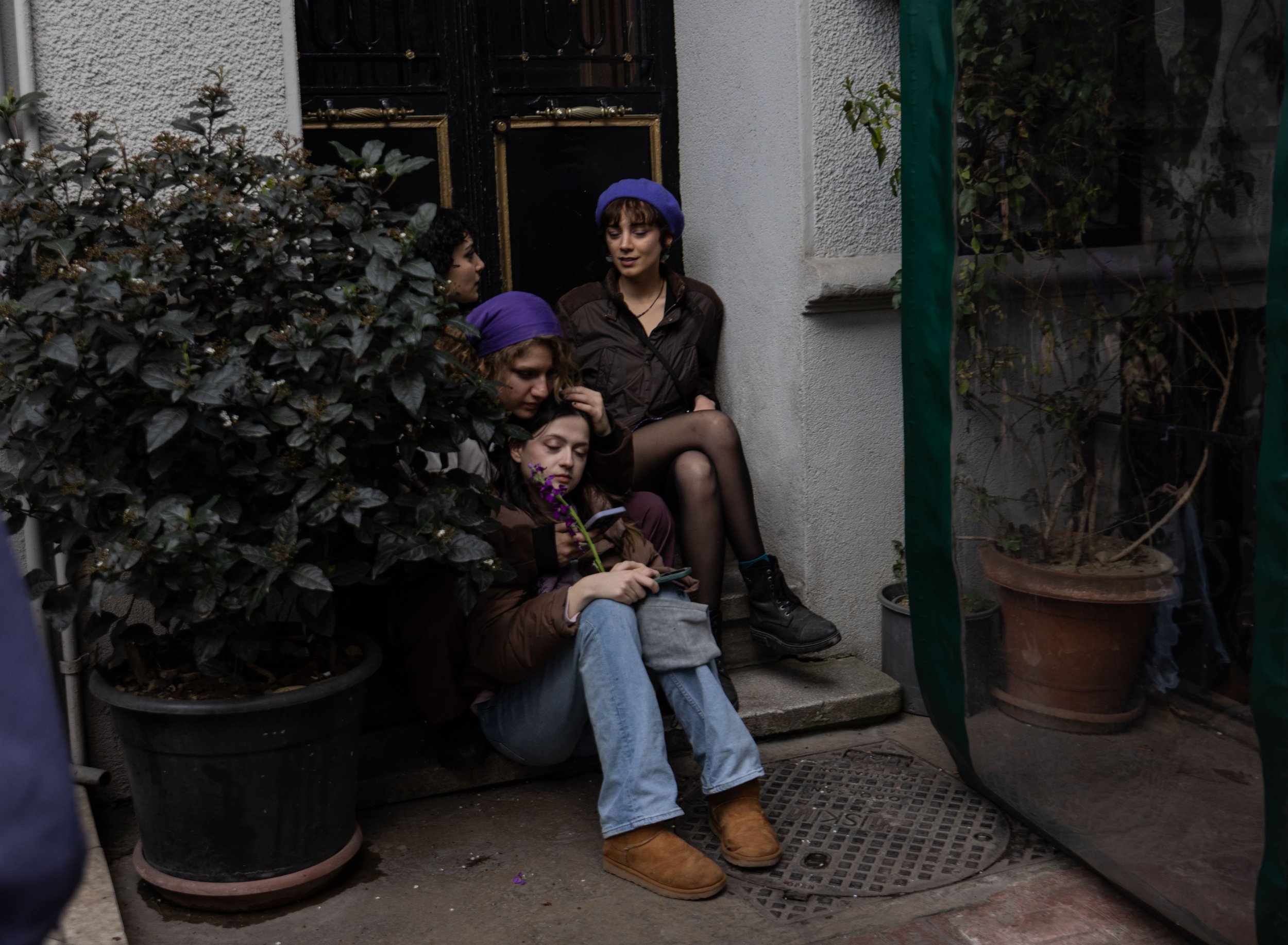  Four female students sit discretely outside a bar in Istanbul after the president made a new order that people couldn’t congregate in groups of four or more.  