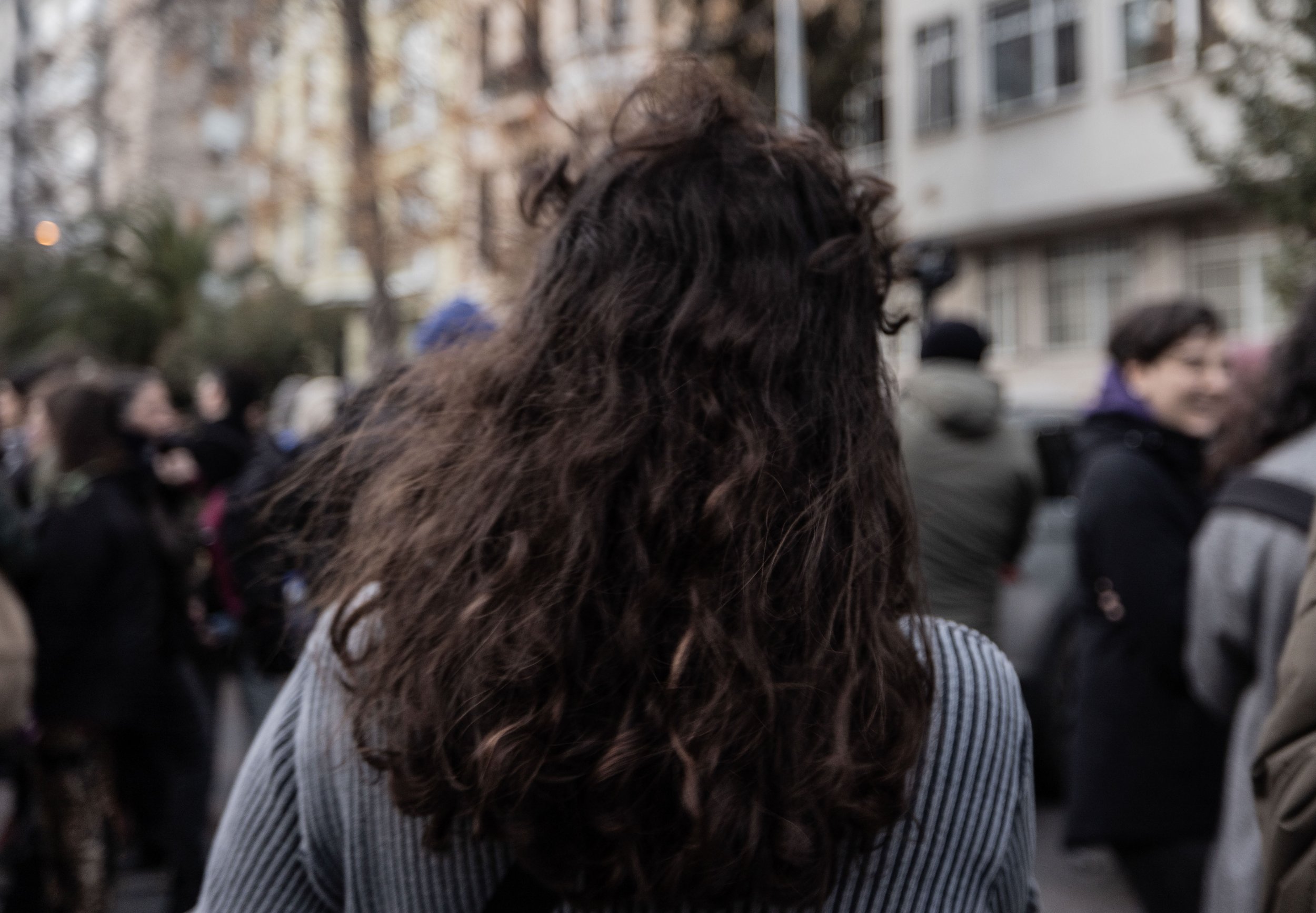  Zeynep walks through a crowd of women  near Takysm square prior to the official gathering of women protesting the Turkish government on International Women’s Day. 