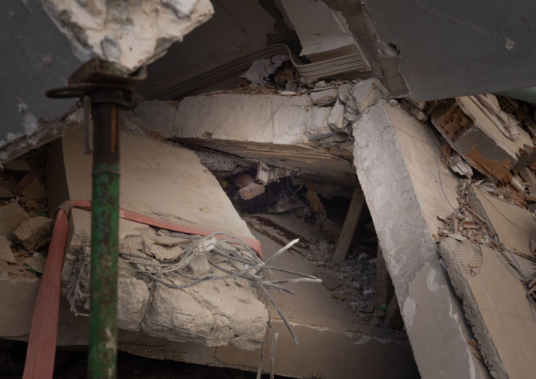  A foot of an unidentified deceased person trapped underneath a collapsed building in Hatay, Turkey on February 13, 2023. 