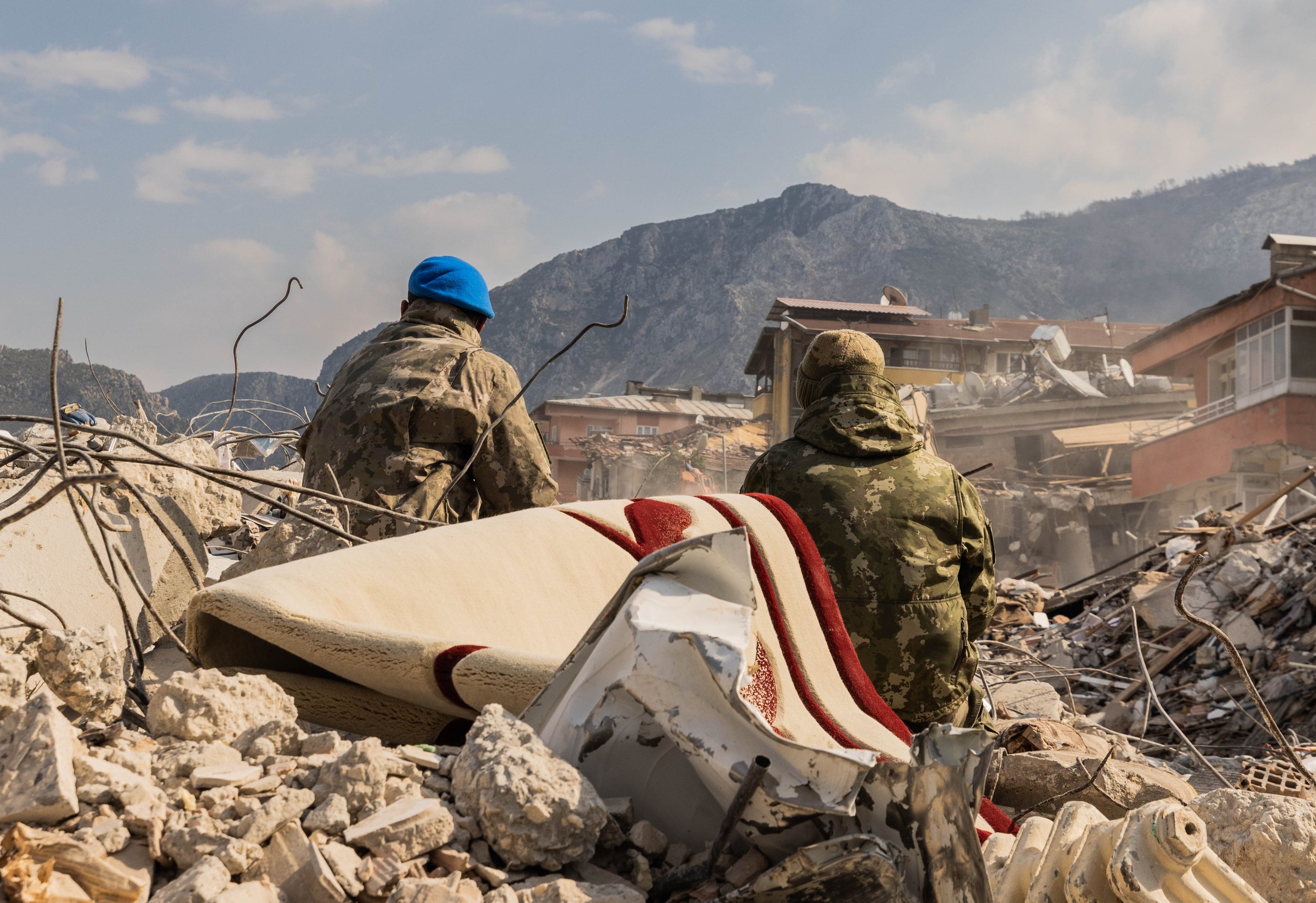  Two Turkish military members sit in the debris of buildings in Hatay, Turkey On February 11, 2022.  