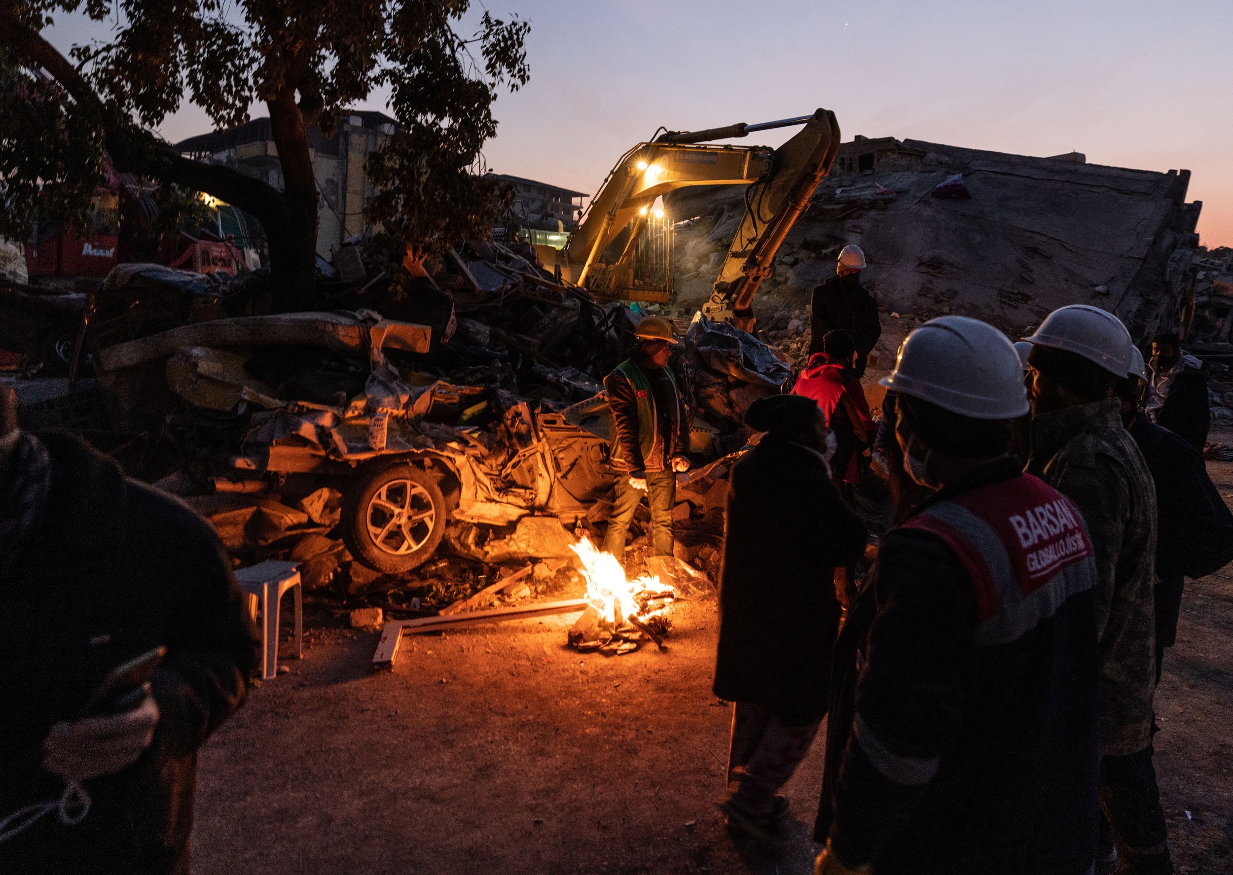  Man-made fires keep rescue workers in Hatay, Turkey warm as they continue to search for bodies through the night.  