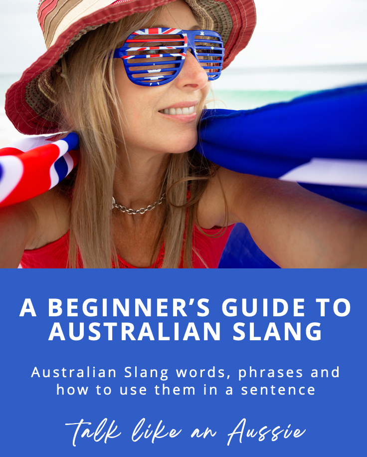 A woman at the beach wearing a sunhat, star-shaped sunglasses with an Australian flag design, and holding a surfboard. The cover title reads: 'A Beginner's Guide to Australian Slang - Australian Slang words, phrases and how to use them in a sentence. Talk like an Aussie.'