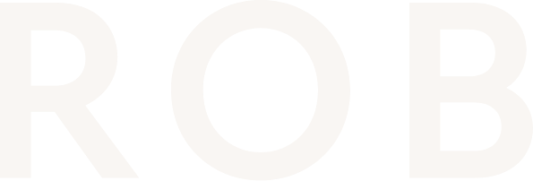 Close-up of white text spelling 'ROB' on a black background.