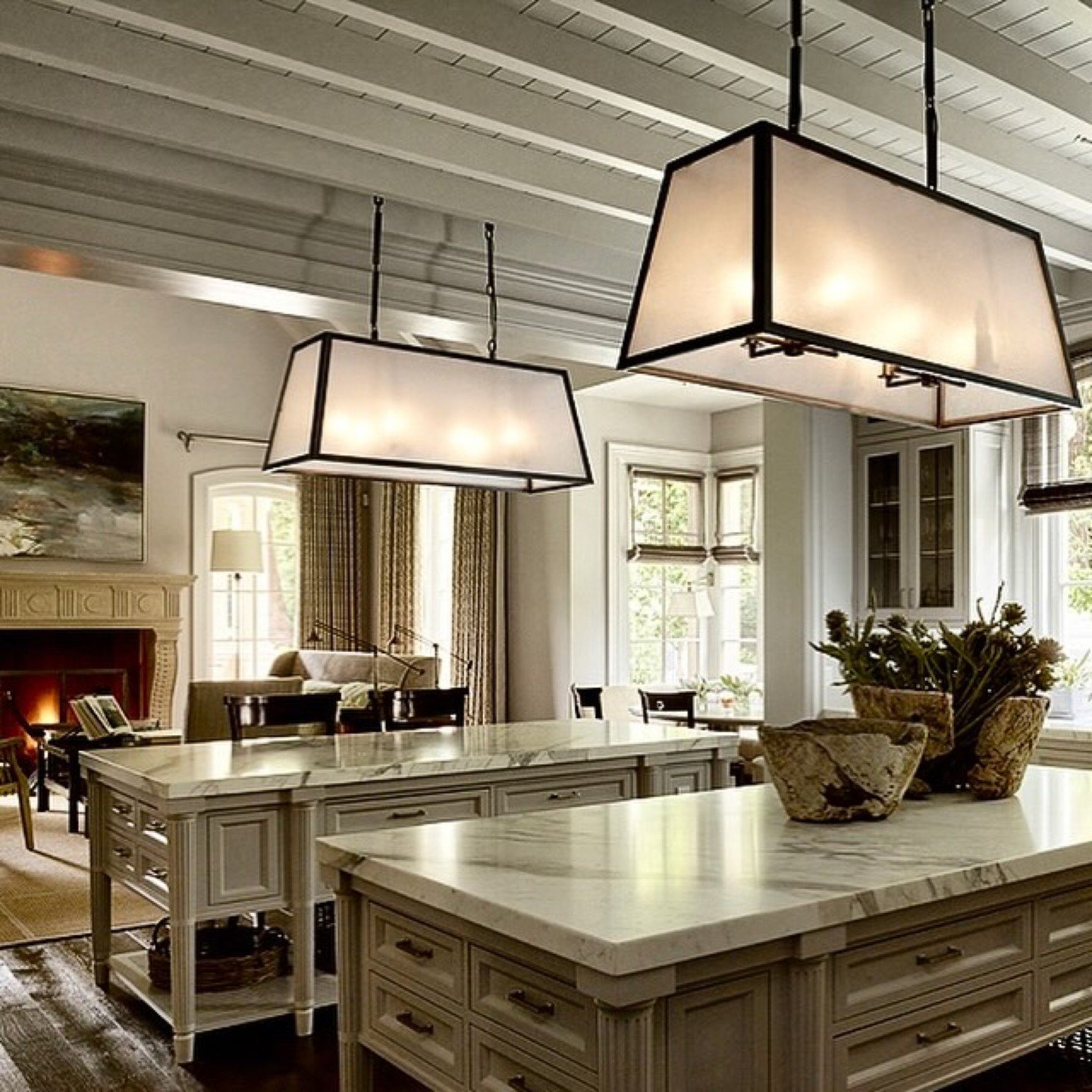 The Wiseman Group strikes again with a breathtaking masterpiece! Custom twin island pendants feature dark antique fabric panels from @phoenixdaylighting, adding an unexpected touch of sophistication and elegance. Elevate your space with refined light