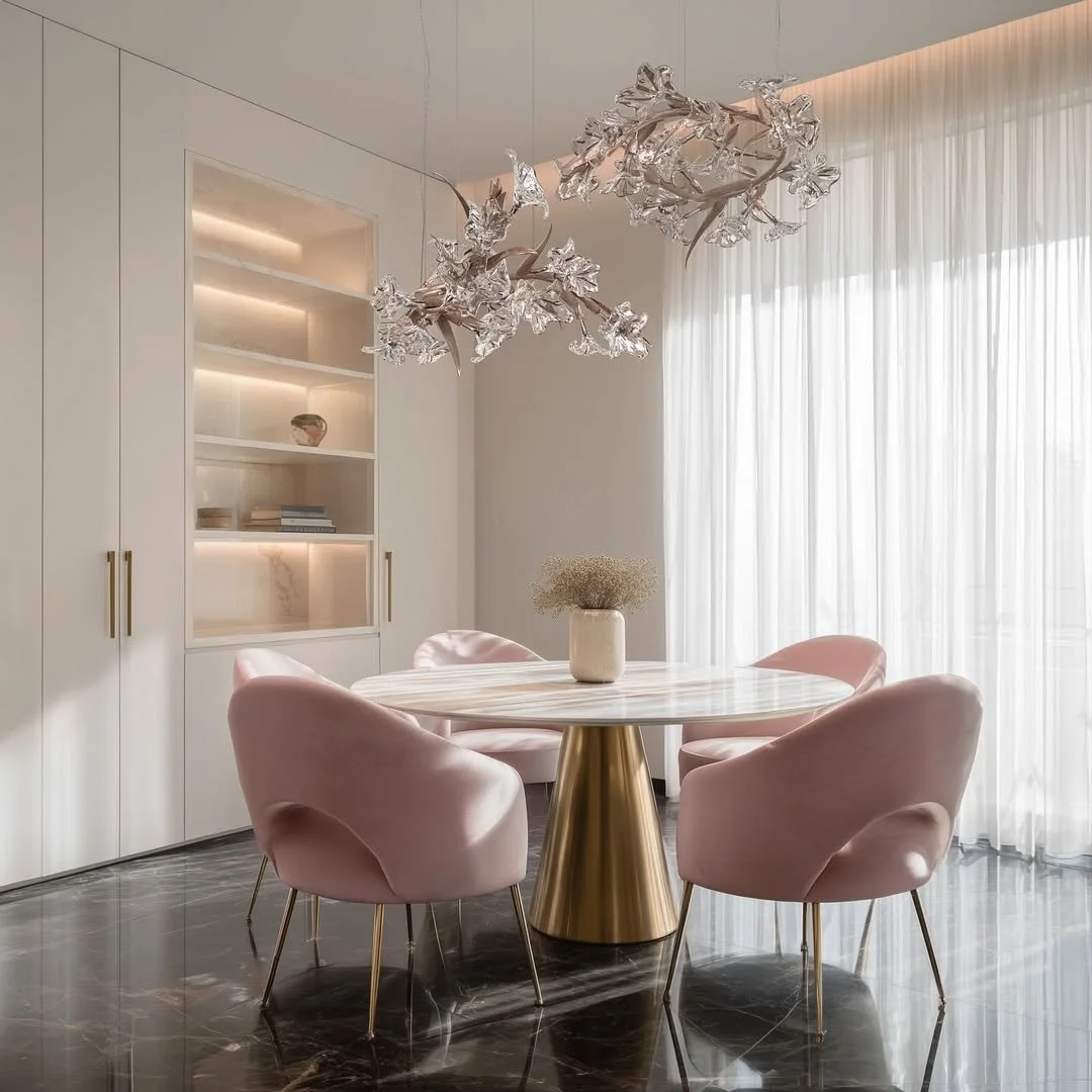 It begins with a whisper of spring &mdash; where light dances across petals of glass and bronze, and strength blooms in delicate form. Suspended above, the Blossom Collection from @seriporganicdesign infuses this serene dining space with a distinctly