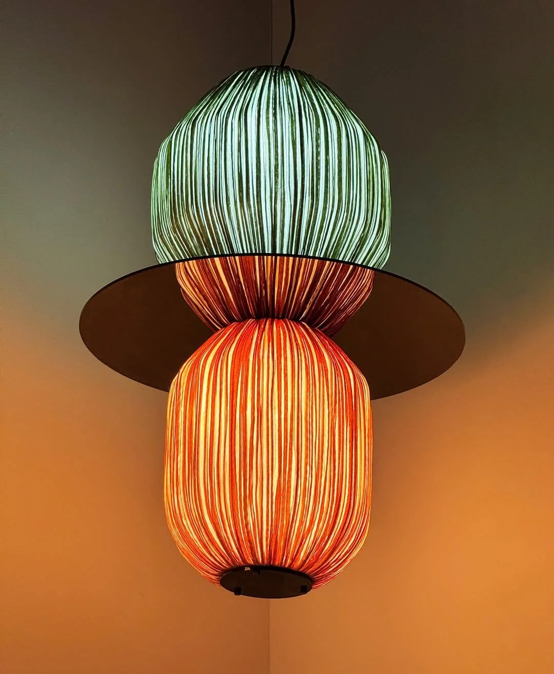A study in color and movement.

The C4/C1 pendant from the Code 130&deg; collection by @aqua_creations layers Grass and Orange silk into a luminous, sculptural statement&mdash;light, reimagined.