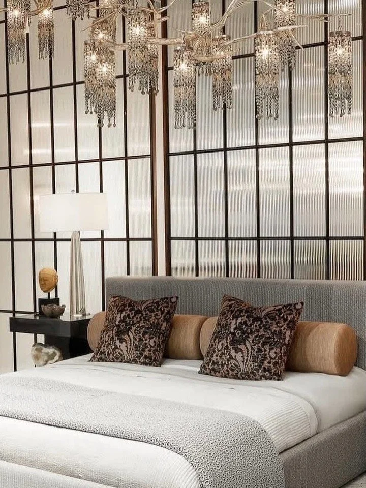 A bedroom composed in layers of light and form.

The Van Ness King Bed from @allanknightdallas anchors the room with confident proportion and tailored presence. Above, the double Coral Sea Chandelier adds a touch of shimmer &mdash; sculptural, radian