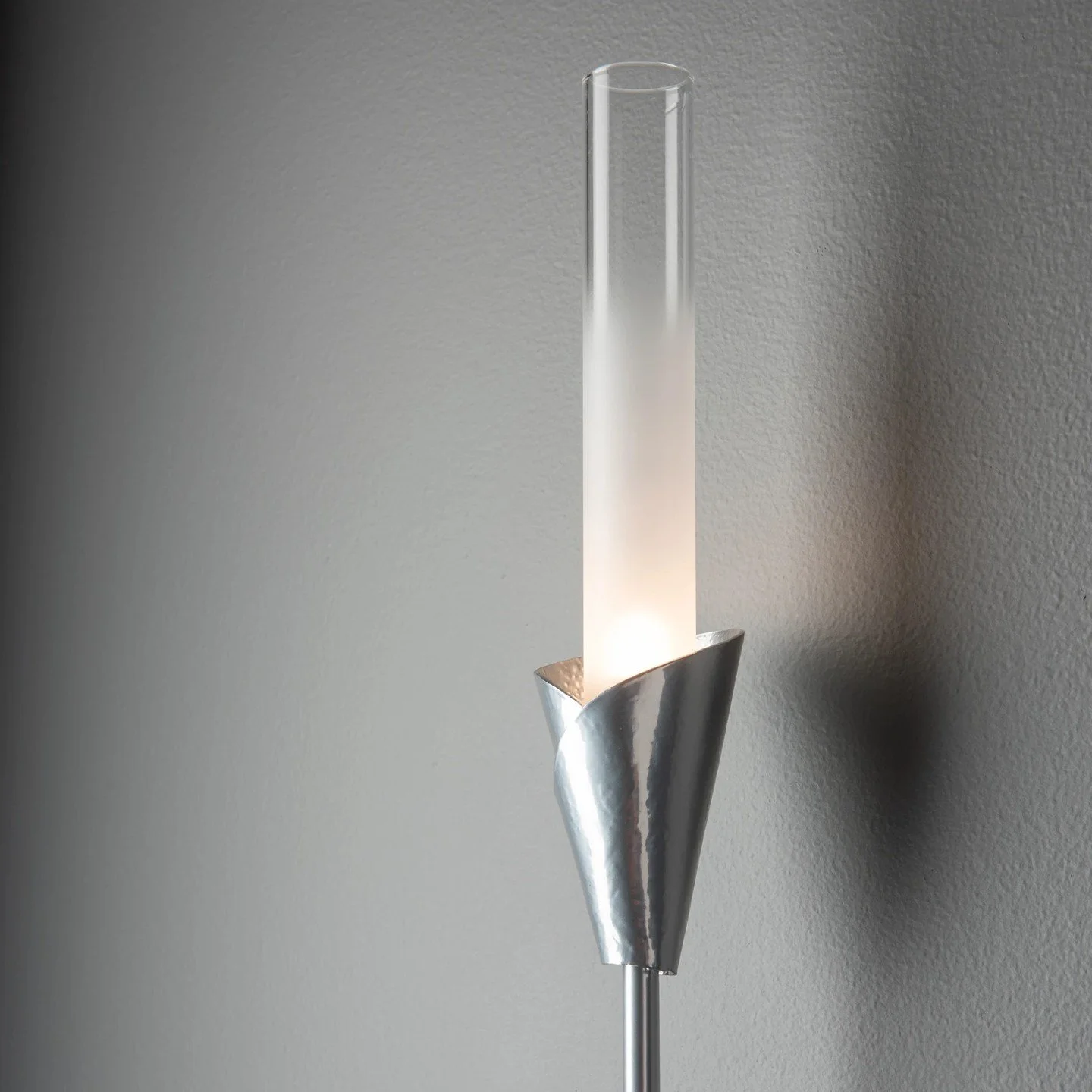 The Lilium Sconce by @hubbardtonforge.

Rising nearly two feet tall, its slender form sprouts upward to illuminate the space. Hand-forged with an artisan-crafted bob&egrave;che and a tall cylindrical glass that fades from frosted to clear, Lilium bal