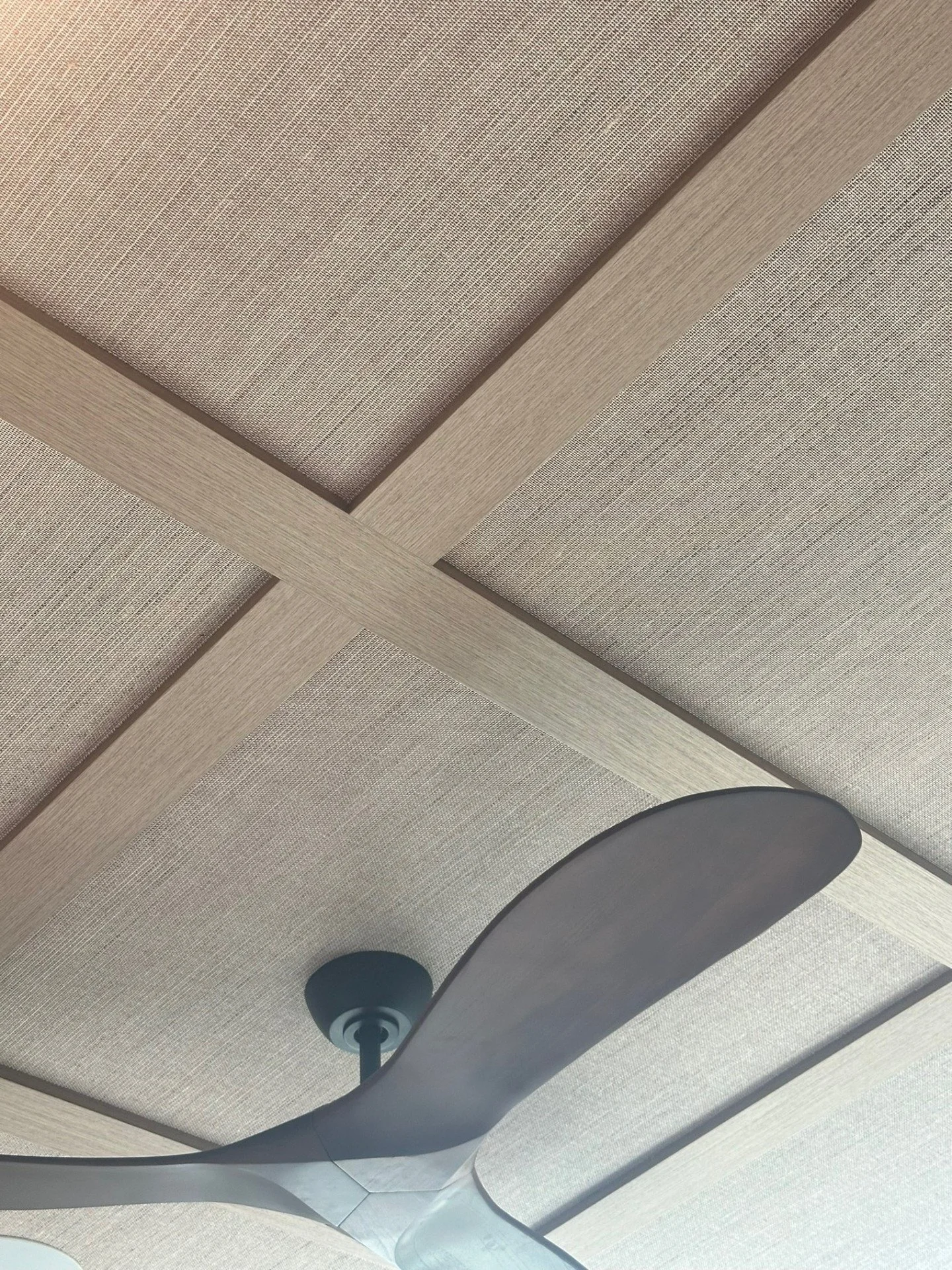 The ceiling tends be an ignored space but can have such a big impact! 

In a bedroom, I like creating a dramatic ceiling to make the room feel more cozy. In this Primary Suite, we did a walnut wood veneer over the existing beams and a grasscloth wall