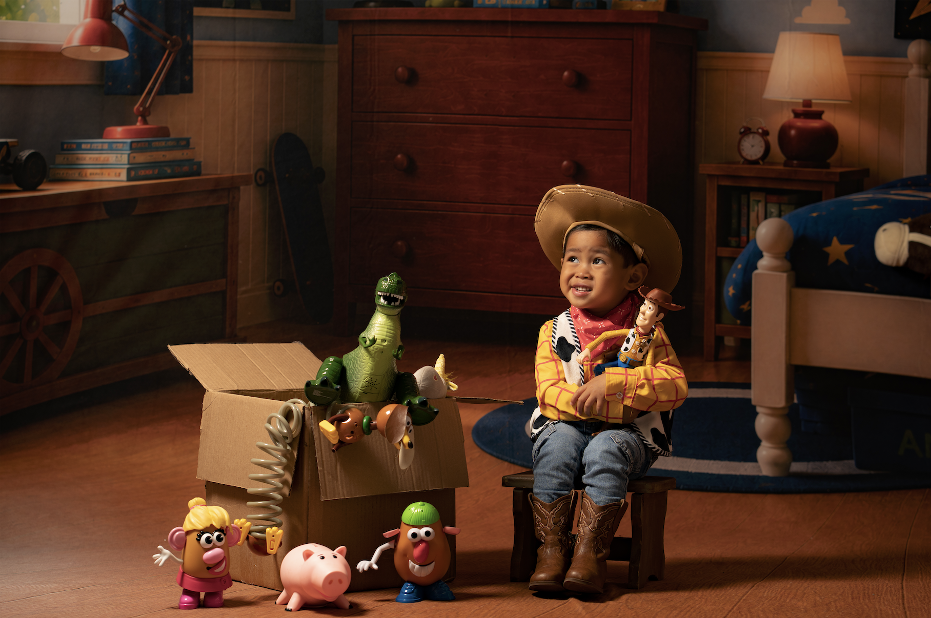 Toddler boy in a Woody costume celebrating his birthday during a Toy Story mini session in an Andy’s Room studio setup in Clarksville, TN