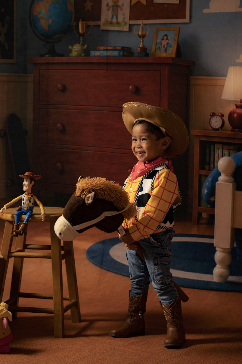  Toddler boy in a Woody costume celebrating his birthday during a Toy Story mini session in an Andy’s Room studio setup in Clarksville, TN