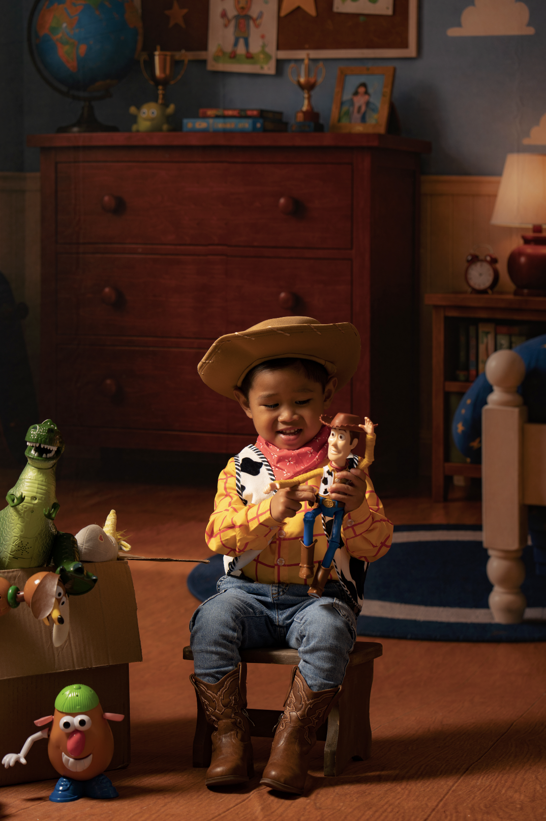 Toddler boy in a Woody costume celebrating his birthday during a Toy Story mini session in an Andy’s Room studio setup in Clarksville, TN