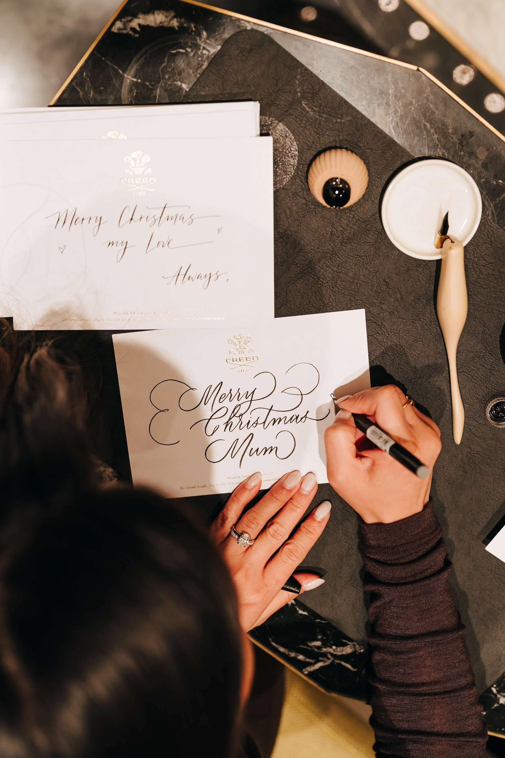 Live calligraphy for Creed by Lilac Scrip Calligraphy for Christmas Event