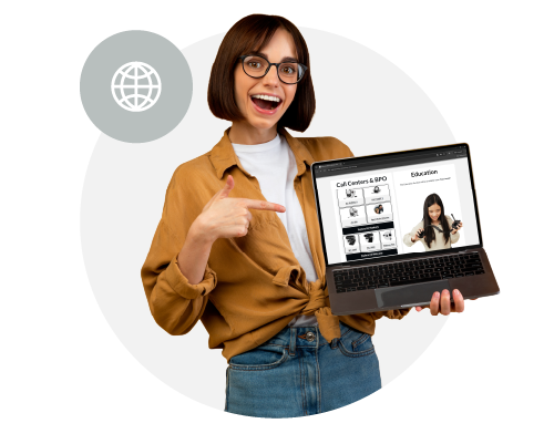 A woman with glasses and a bob haircut smiling and pointing to a laptop she is holding, with a virtual presentation on the screen that includes a woman and educational icons.