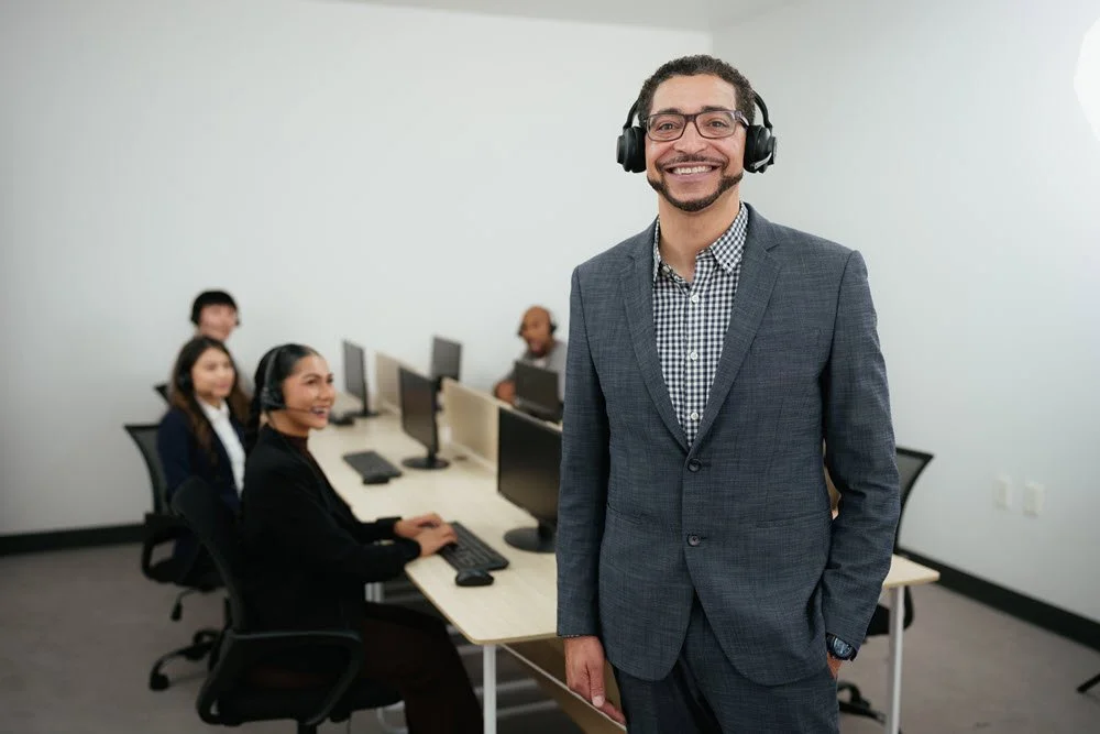 Cyber Acoustics call center agents wearing headsets on the floor