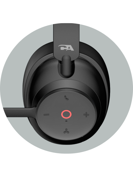 Close-up of a wireless headset with noise cancellation earcup control panel showing center mute button with red LED, volume controls, call button, and device-switch button